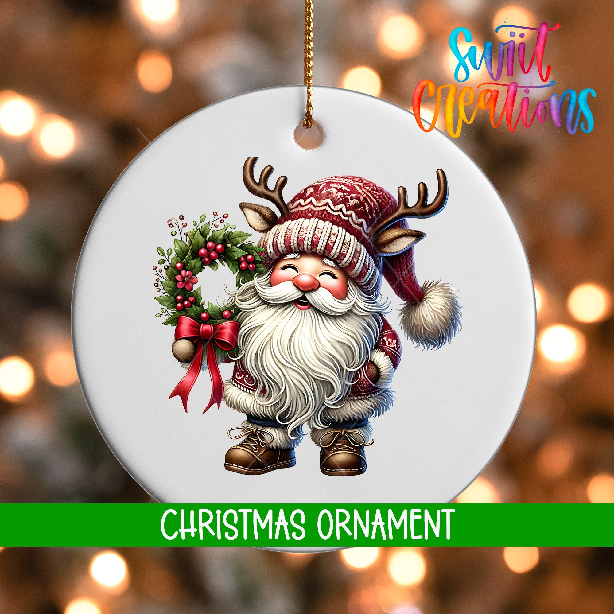 A white Christmas ornament featuring a smiling Santa Claus with antlers and a wreath, set against a blurred background of Christmas lights.