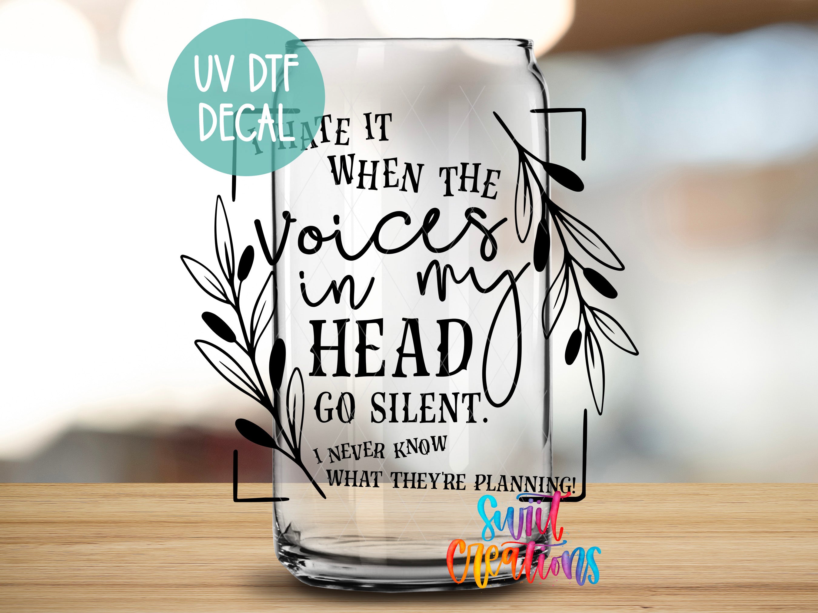 a glass with a quote on it sitting on a table