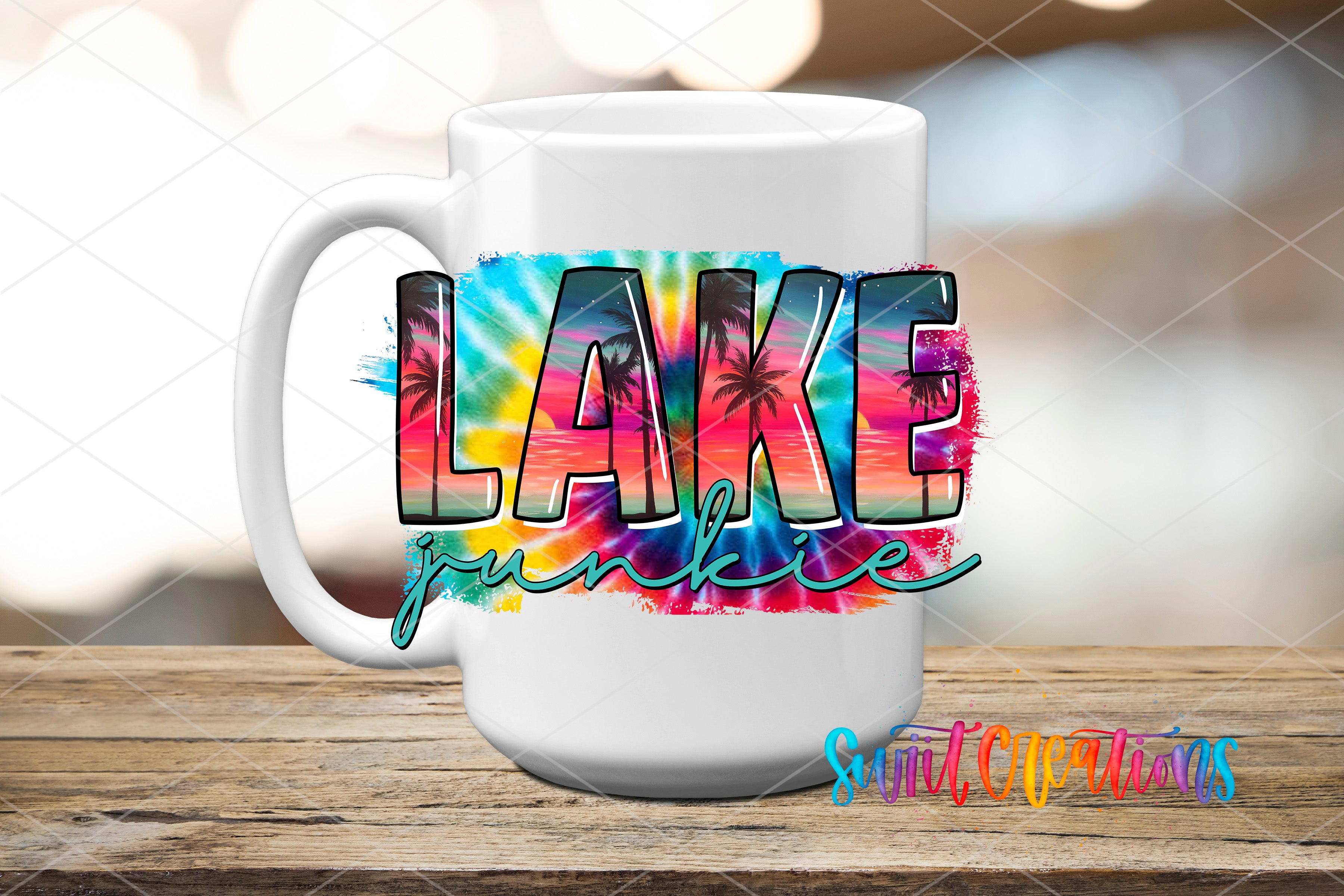 A white mug with a colorful tie-dye design featuring the word "LAKES" and palm trees.