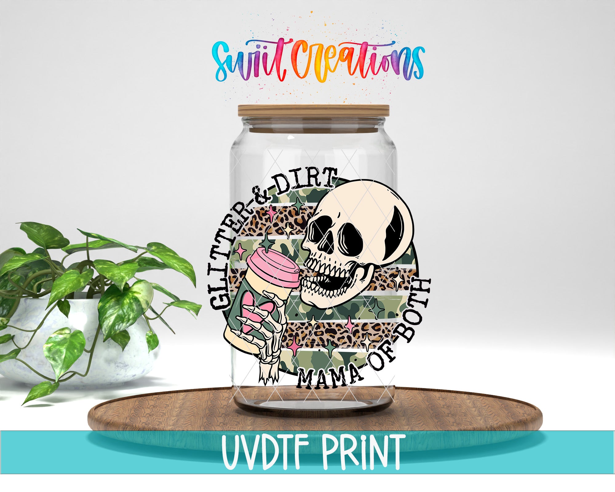 a glass jar with a skull and floral design, placed on a wooden surface.