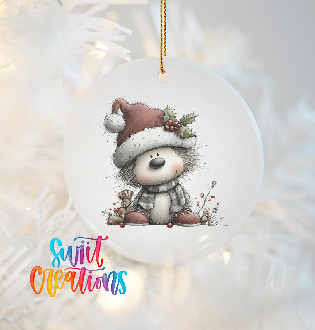 A ceramic ornament featuring a smiling hedgehog wearing a Santa hat and scarf, with berries and a holly leaf on its head, hanging on a Christmas tree.
