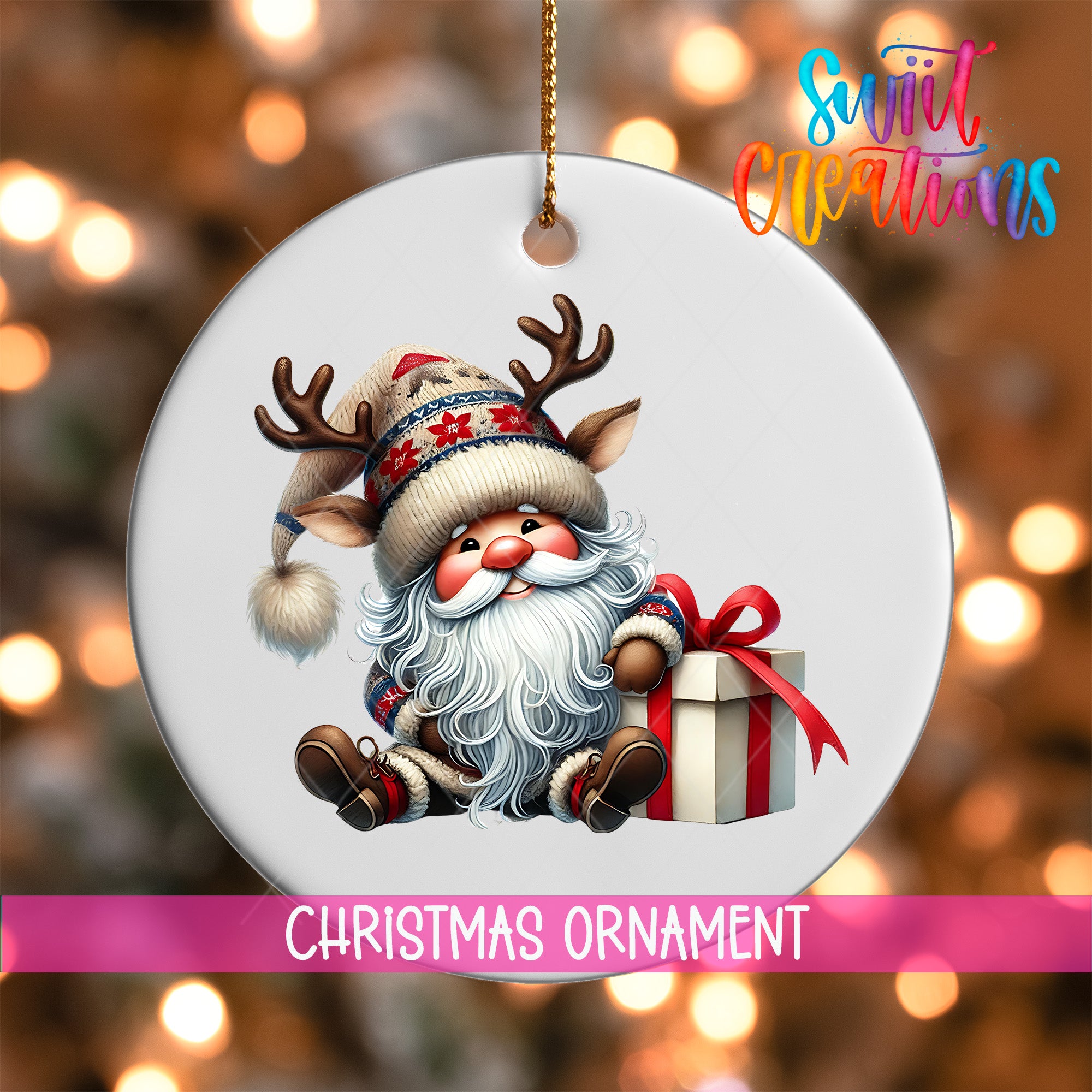 A Christmas ornament featuring a Santa Claus reindeer holding a gift box, with a blurred background of Christmas lights.