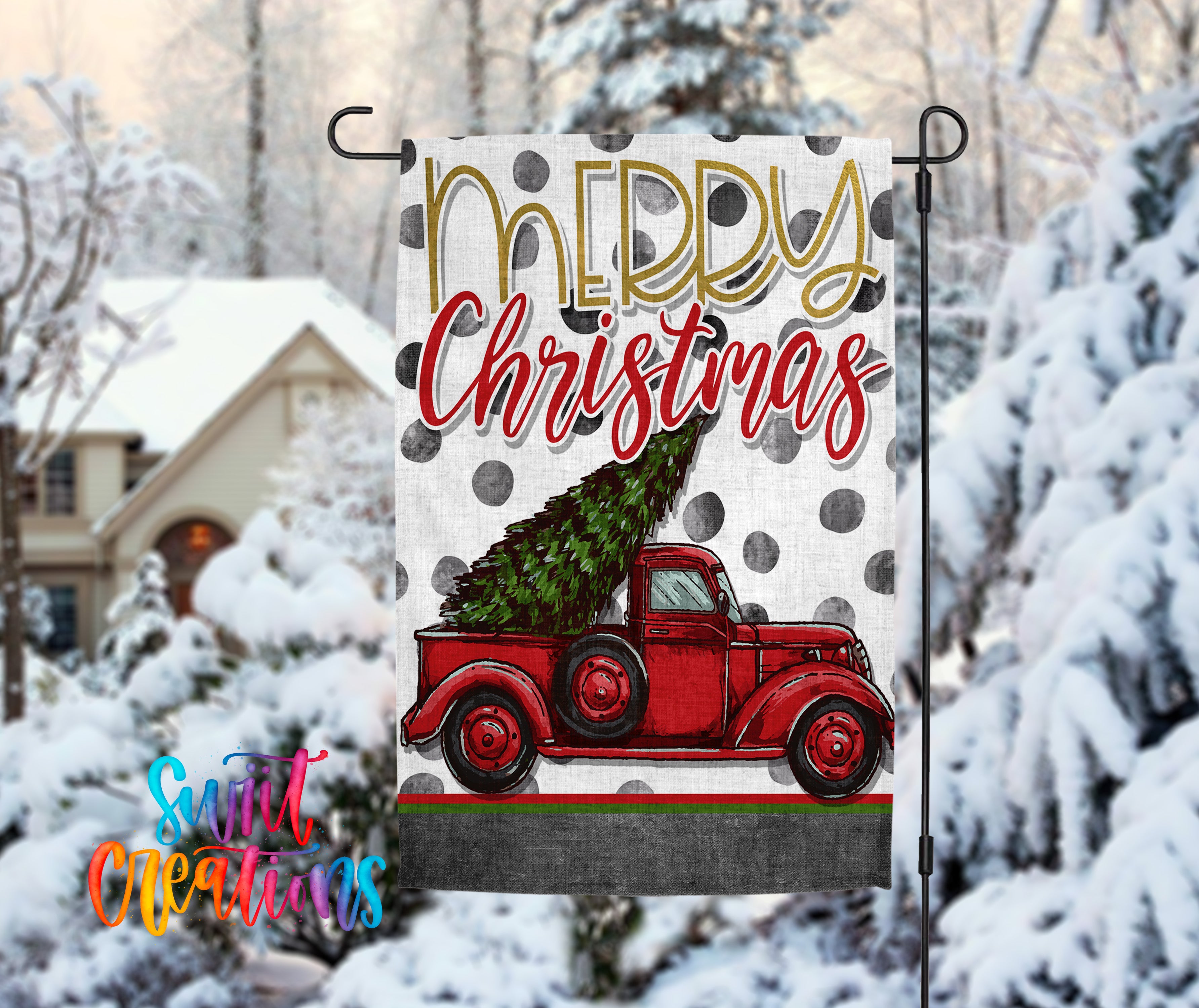 A Christmas-themed flag with a red truck carrying a Christmas tree is displayed in front of a snowy landscape with a house and trees in the background.