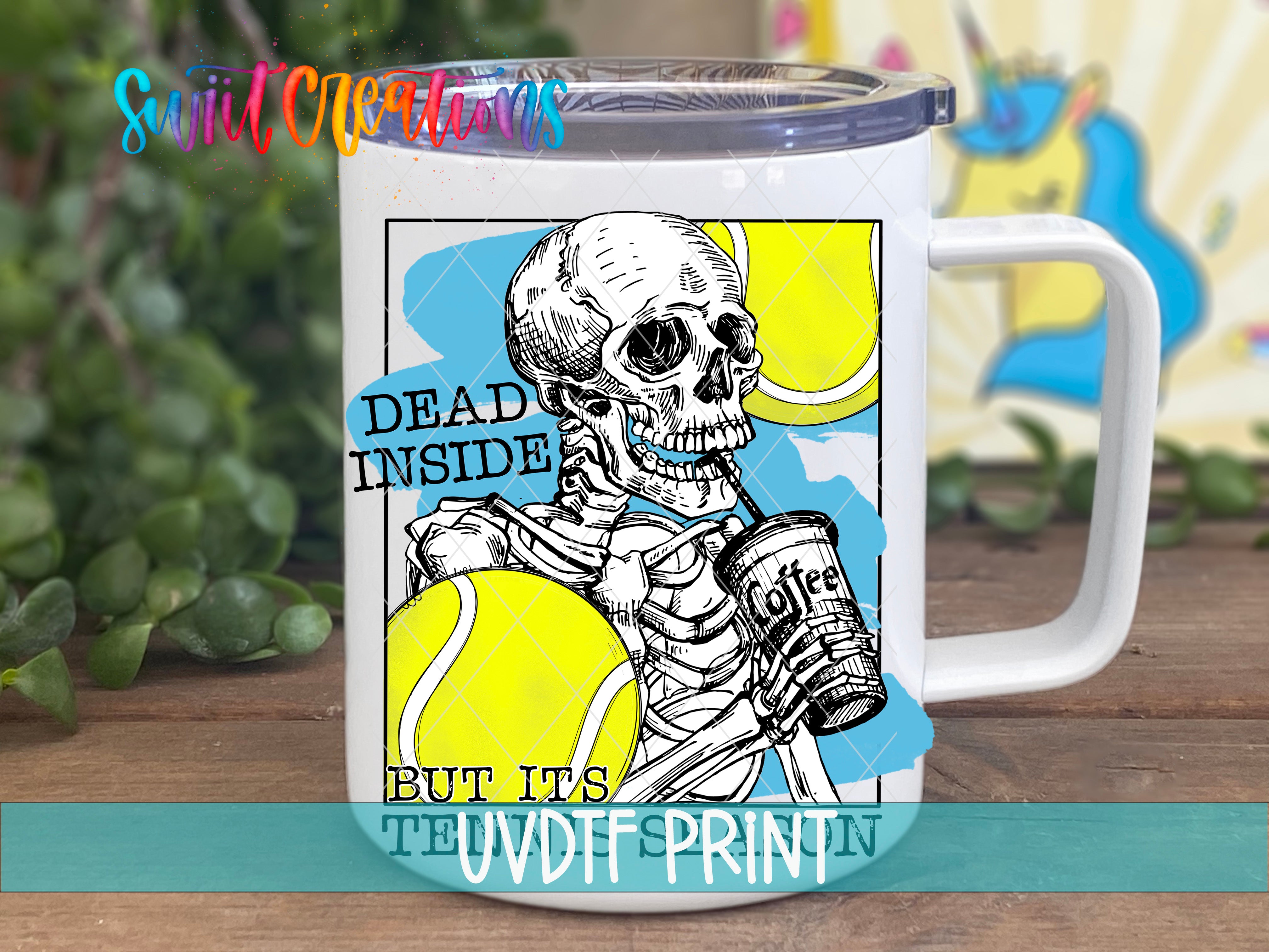 a white coffee mug with a skeleton holding a tennis ball