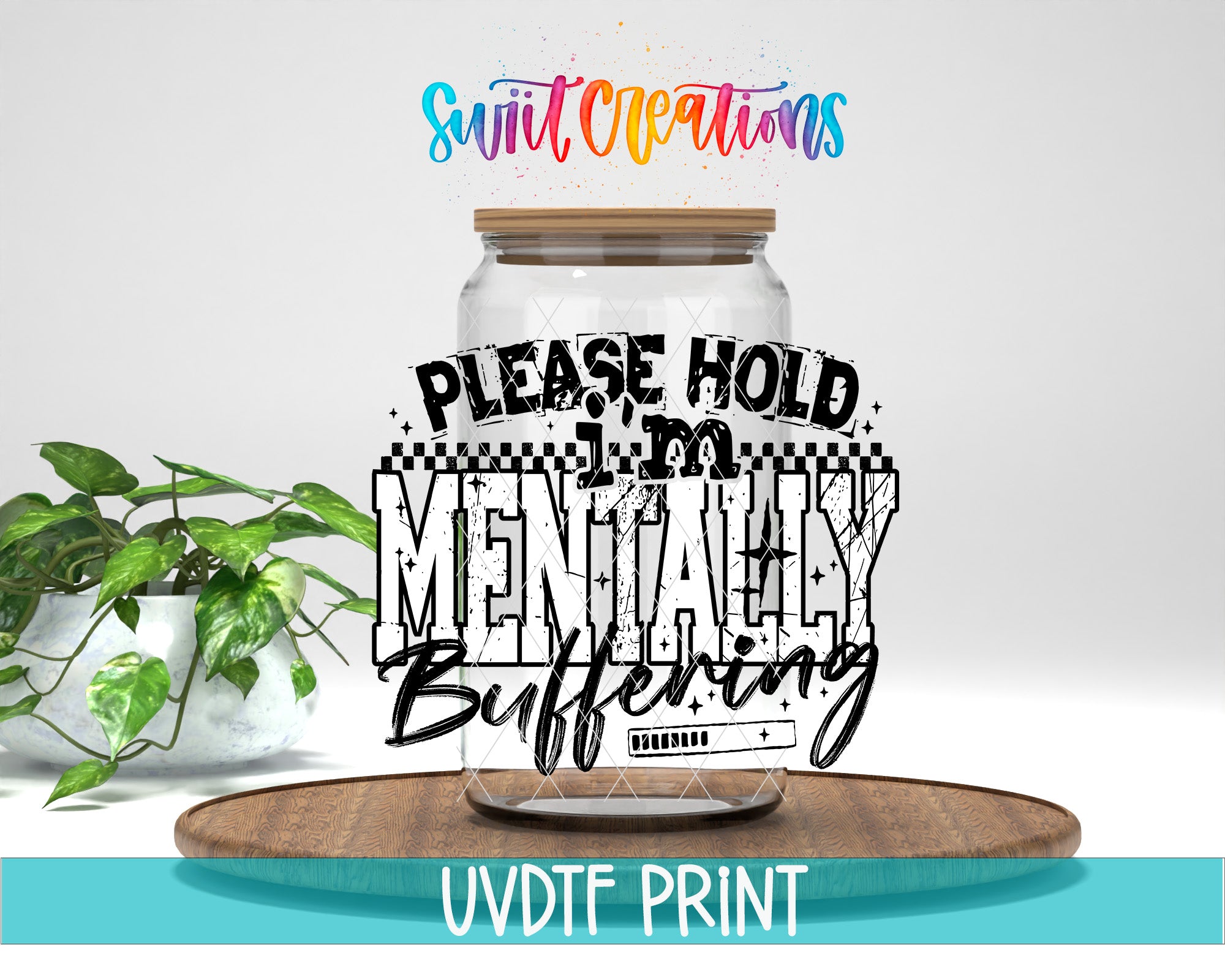 a large glass jar with a wooden lid, placed on a wooden surface. The jar has a label with the text "PLEASE HOLD MENTALITY BUFFERING" written on it. In the background, there is a potted plant, and the text "Swit Creations" is written above the jar.
