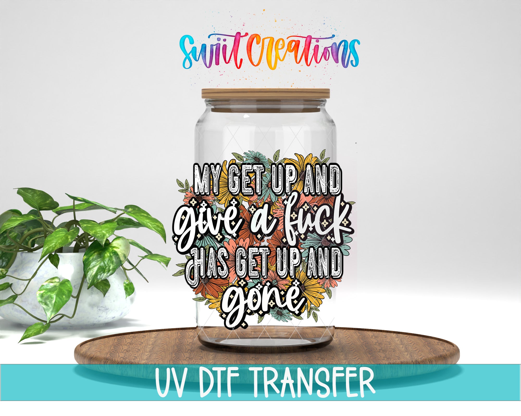 a glass jar with a colorful floral design and text printed on it, placed on a wooden surface.
