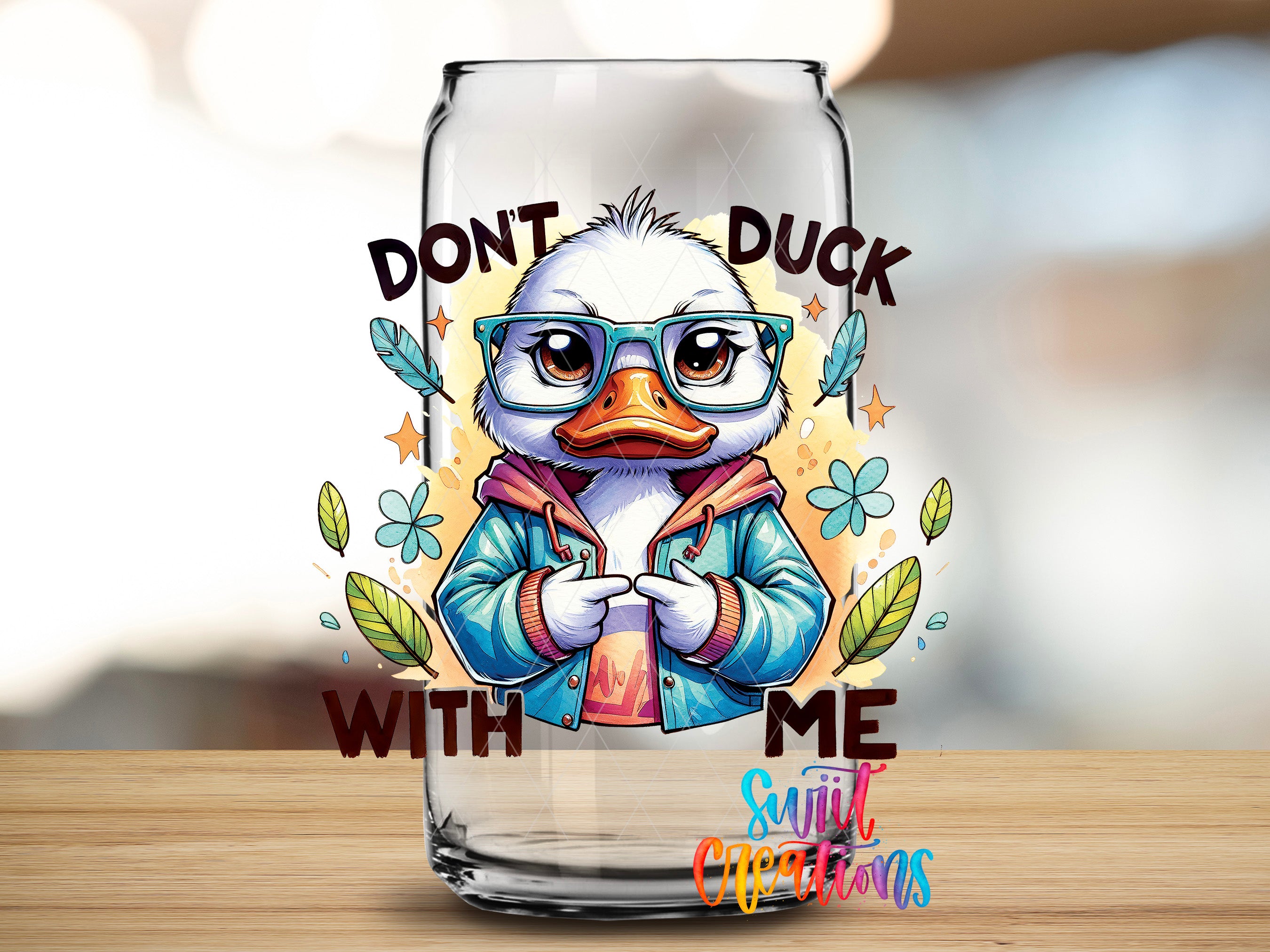 A cartoon duck wearing glasses and a jacket, with the text "DON'T DUCK WITH ME" and "Suitcase Creations" written around it.