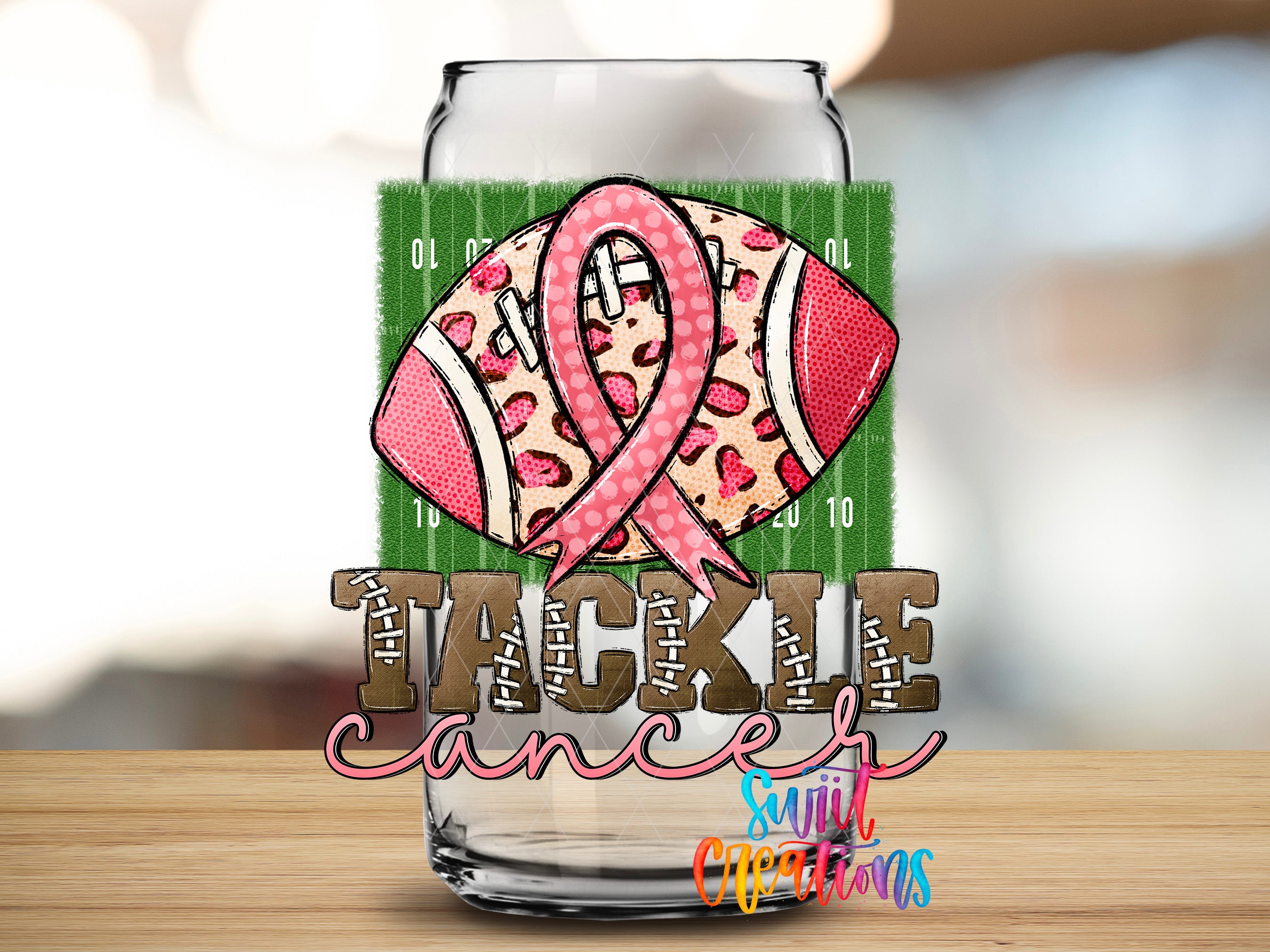 a football with a pink ribbon on it, and the word "TACKLE" written below it.