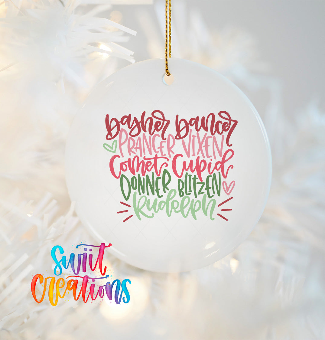 A white ornament with colorful text that says "Baker, Baker, Baker, Prancer, Vixen, Comet, Cupid, Donner, Blitzen, Rudolph" hanging on a Christmas tree.