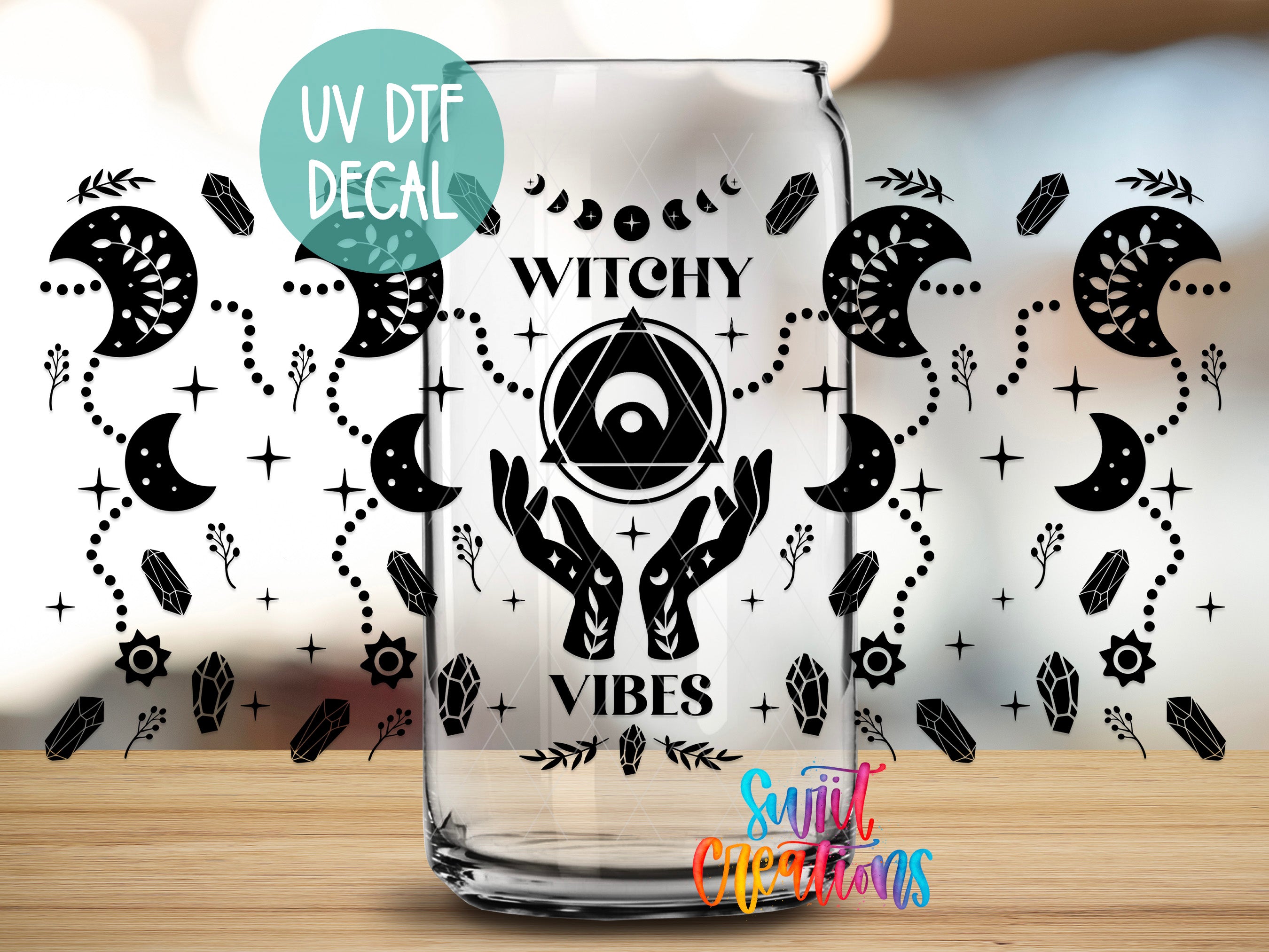 a glass with a UV decal that says "Witchy Vibes" and includes various mystical and supernatural symbols such as crescent moons, crystals, and a pentagram.