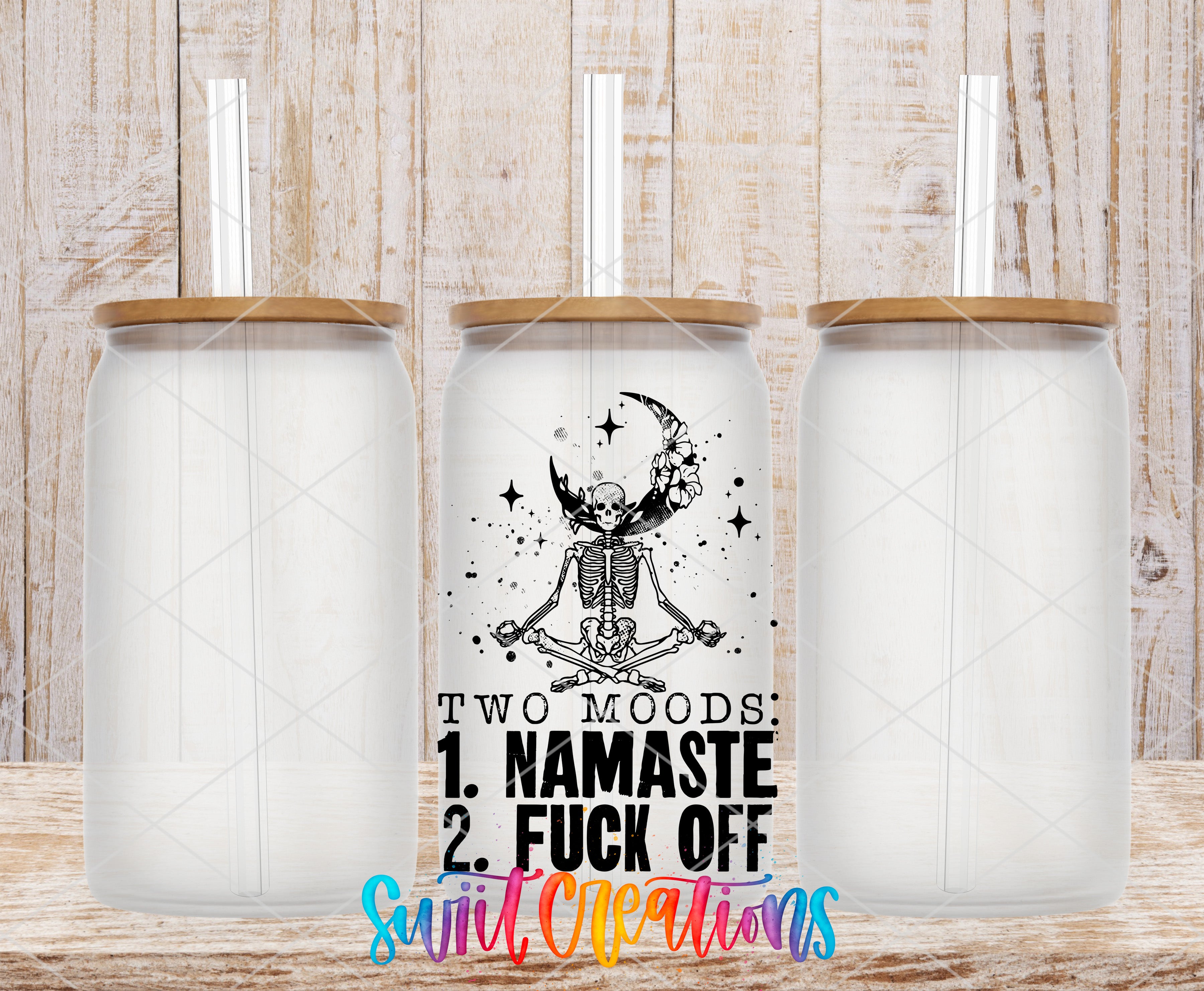 Three clear glass cans with the Two Moods Namaste or Fuck Off UV DTF transfer by Swiit Creations