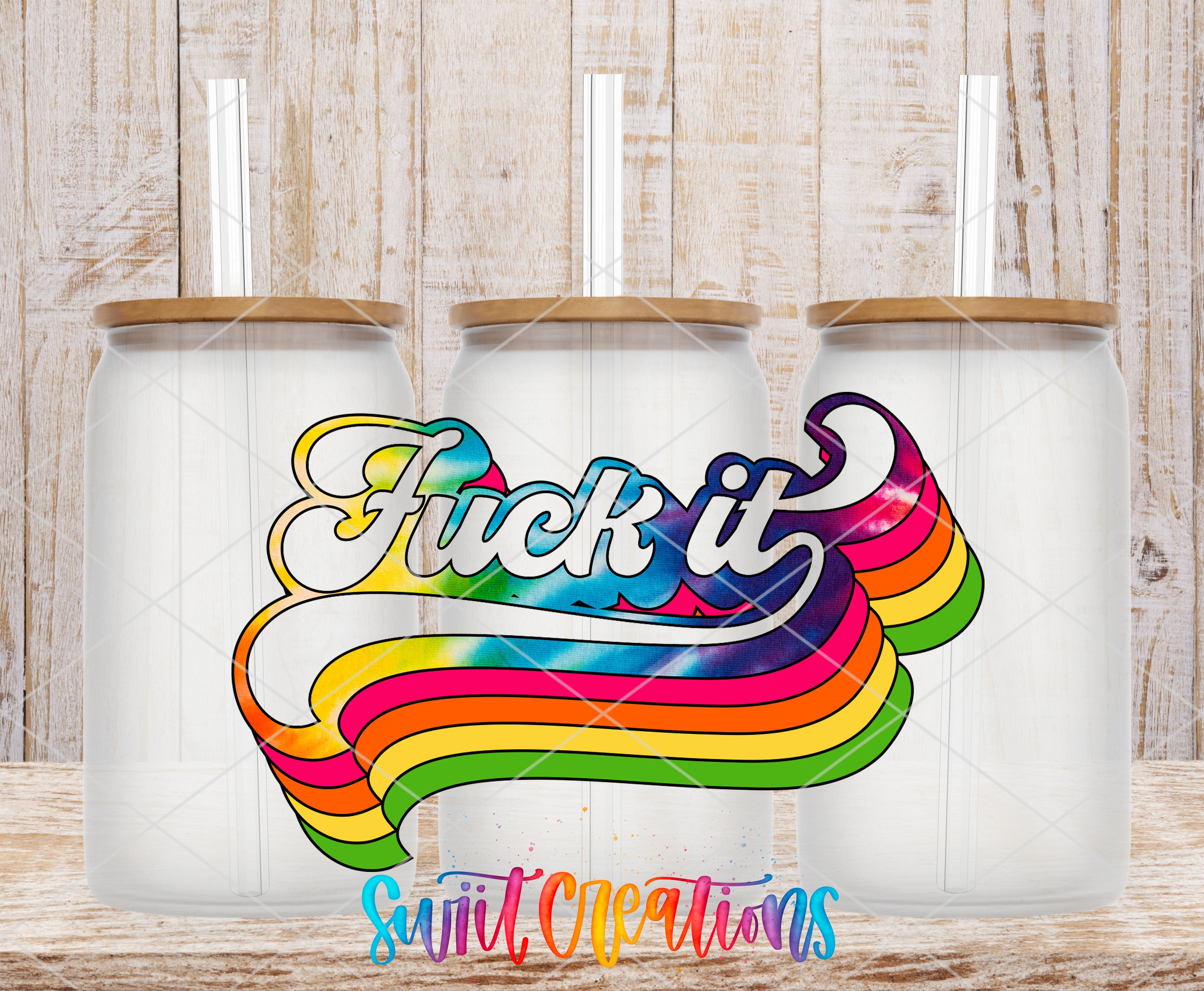 Three clear glass cans with the Fuck It Retro Rainbow UV DTF transfer by Swiit Creations