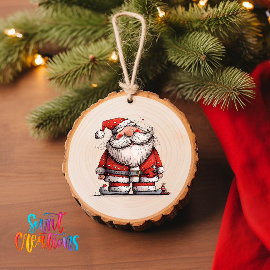 A wooden ornament featuring a cartoon Santa Claus figure is hanging on a Christmas tree, surrounded by pine branches and twinkling lights.