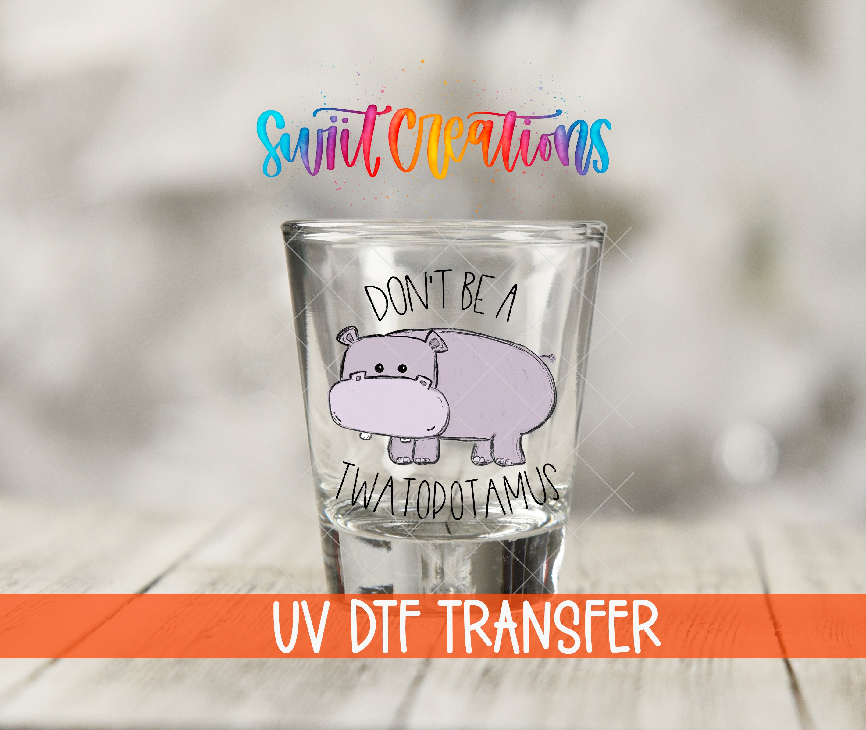 A shot glass with a cartoon hippopotamus and the text "DON'T BE A TWATOPOTAMUS" printed on it.