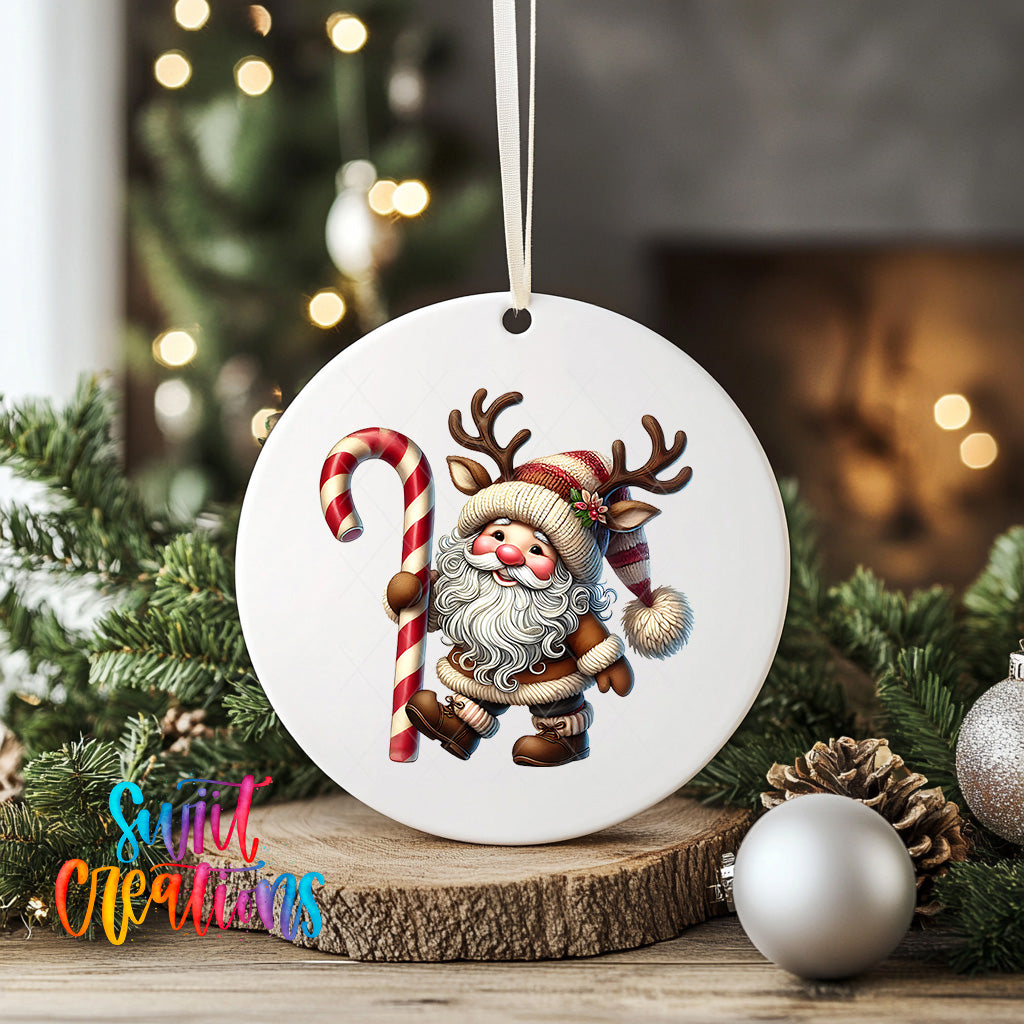 A white ornament featuring a Santa Claus figure holding a candy cane and reindeer antlers, surrounded by Christmas decorations such as pine cones and ornaments.