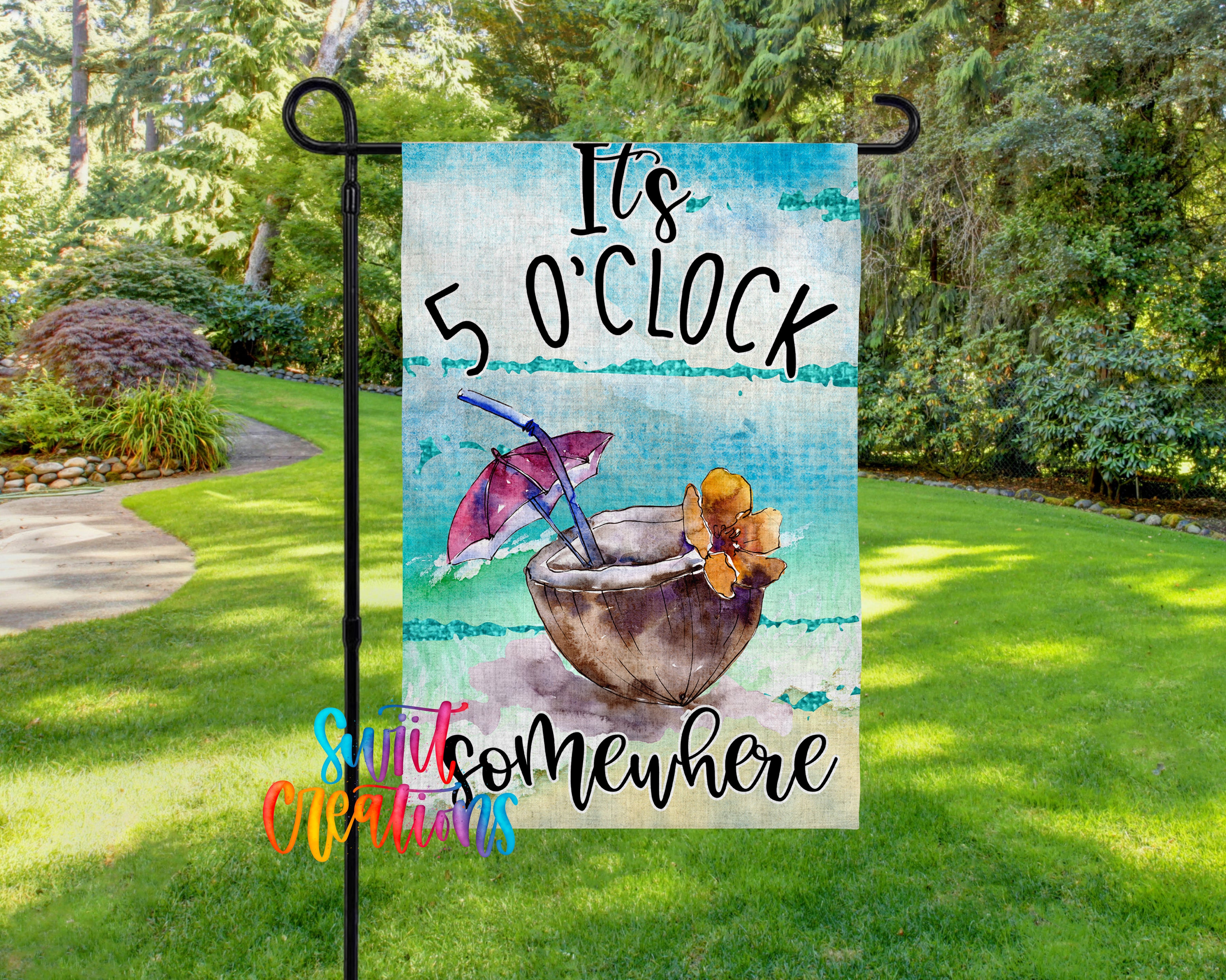 A colorful garden sign with the text "It's 5 o'clock somewhere" and an illustration of a tropical drink with an umbrella.