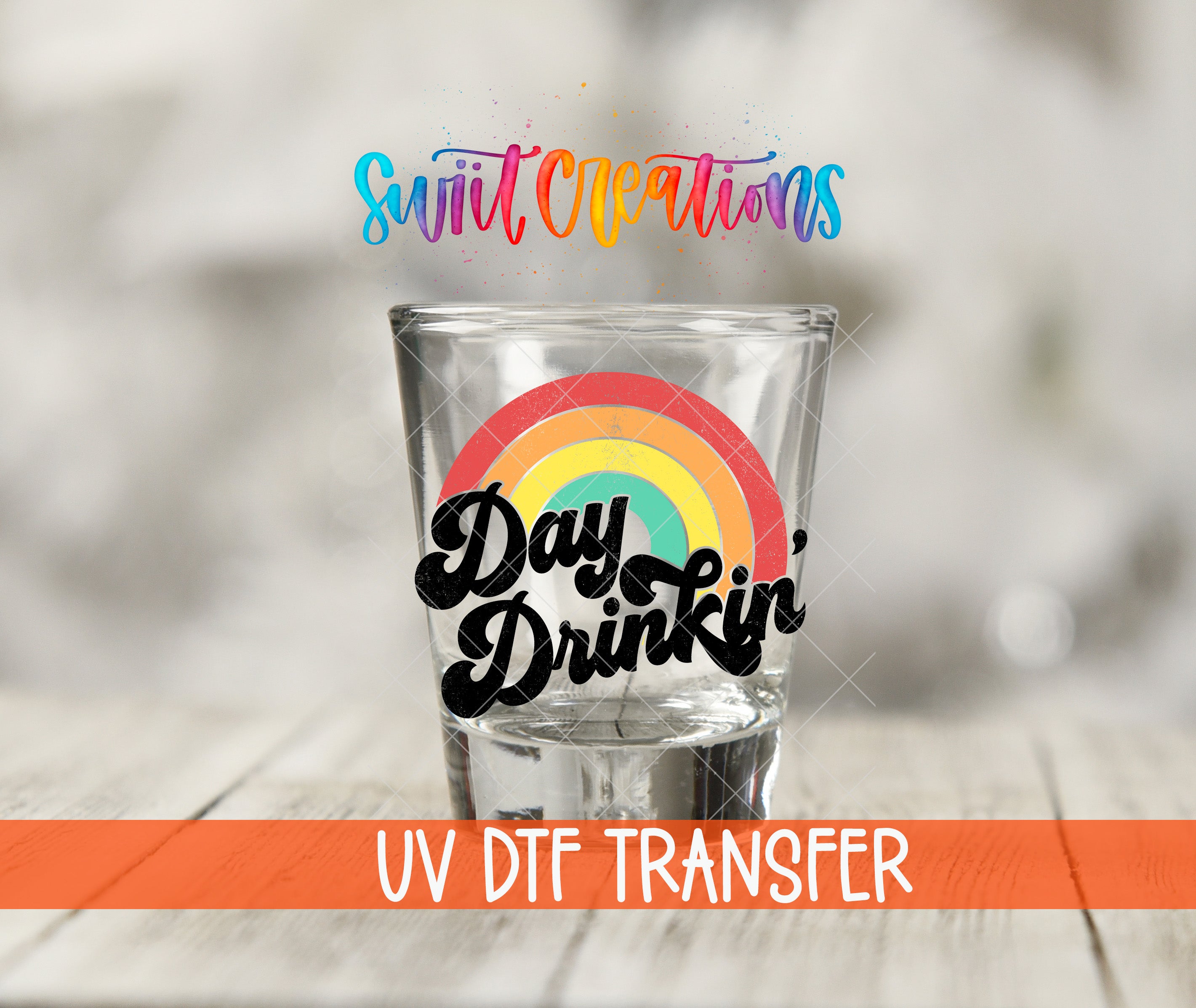 A shot glass with a rainbow design and the text "Day Drinking" printed on it, along with the text "Swift Creations" and "UV Dtf Transfer" below.