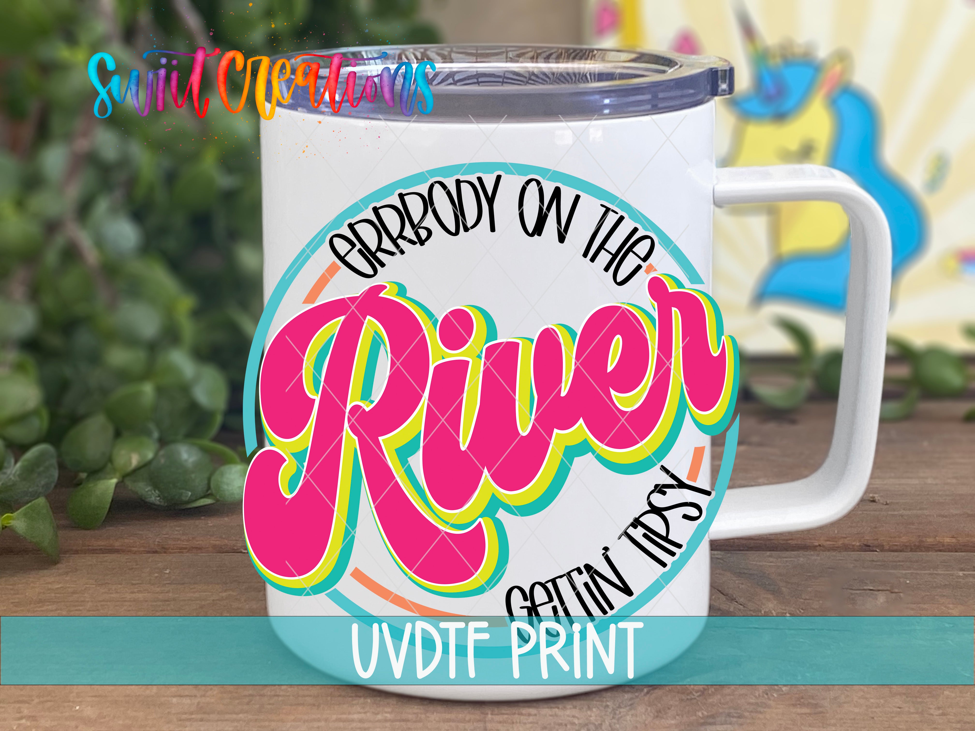 A white mug with a colorful graphic design featuring the text "ARRBODY ON THE RIVER" and "GETIN IPSY" printed on it.