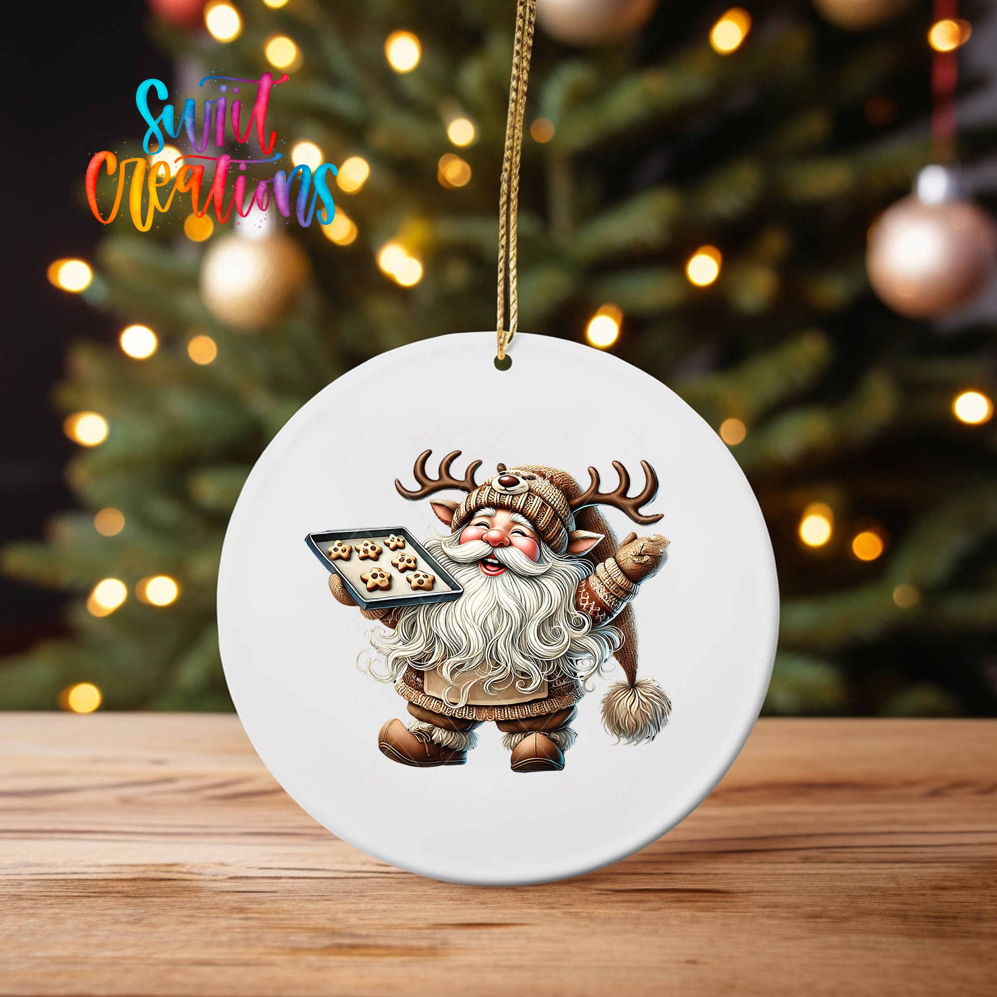 A white ornament featuring a cartoon image of Santa Claus holding a tray of cookies, with a blurred background of a Christmas tree and colorful lights.