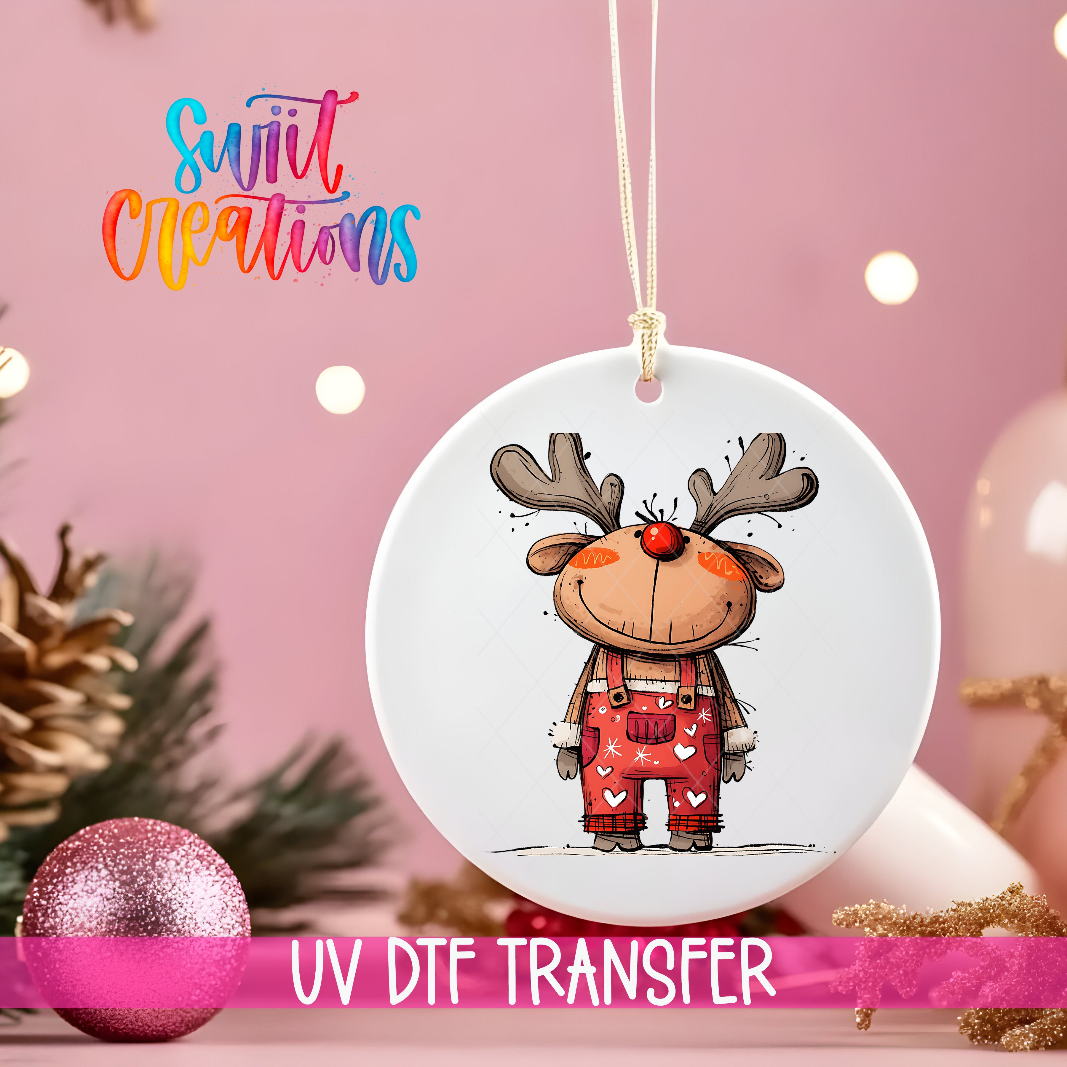 A white ornament with a cartoon reindeer design hangs against a pink background, with a pink glitter ball and pine branches in the foreground.