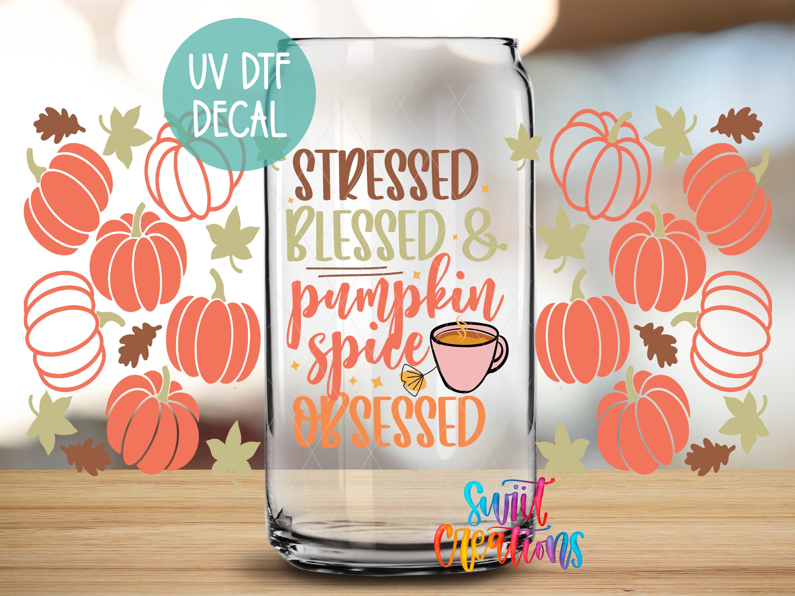 a glass jar with a pumpkin and spice-themed decal on it, placed on a wooden surface.