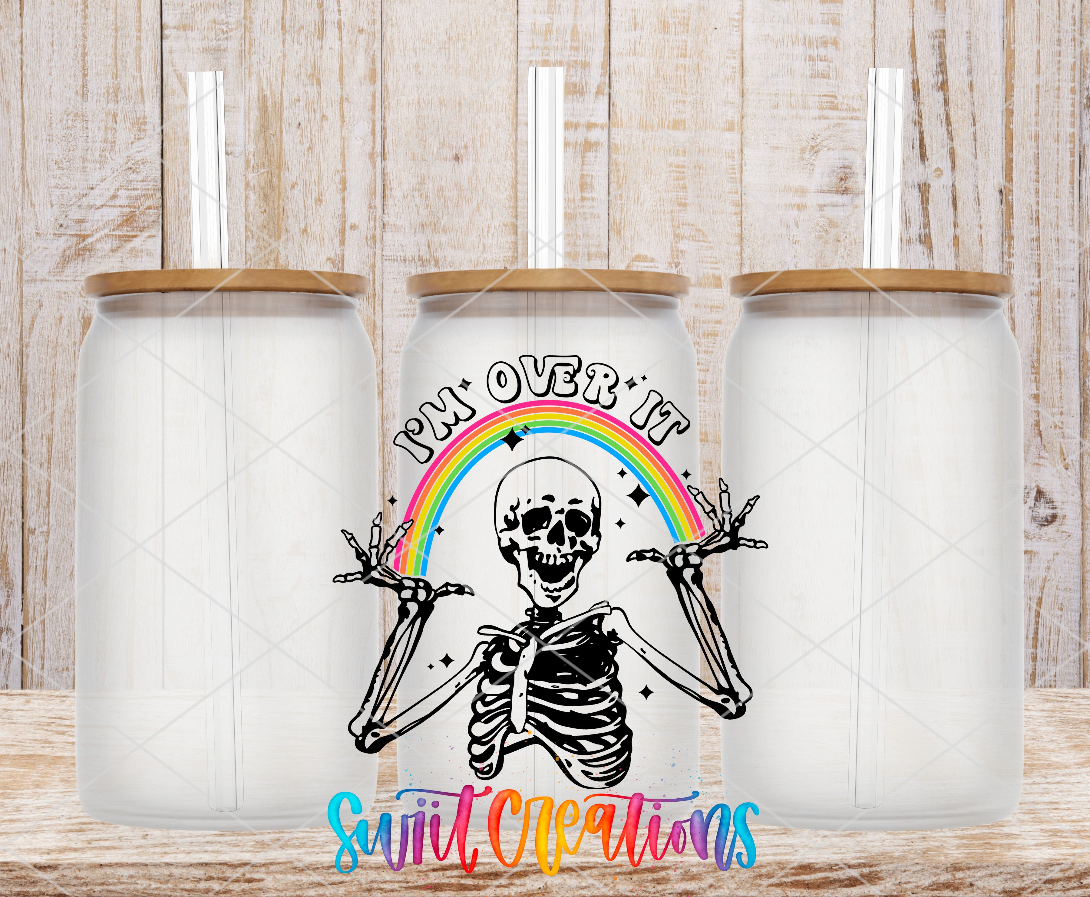 Swiit Creations UV DTF Sassy Skeleton I’m Over It Rainbow transfer shown on a clear glass can set