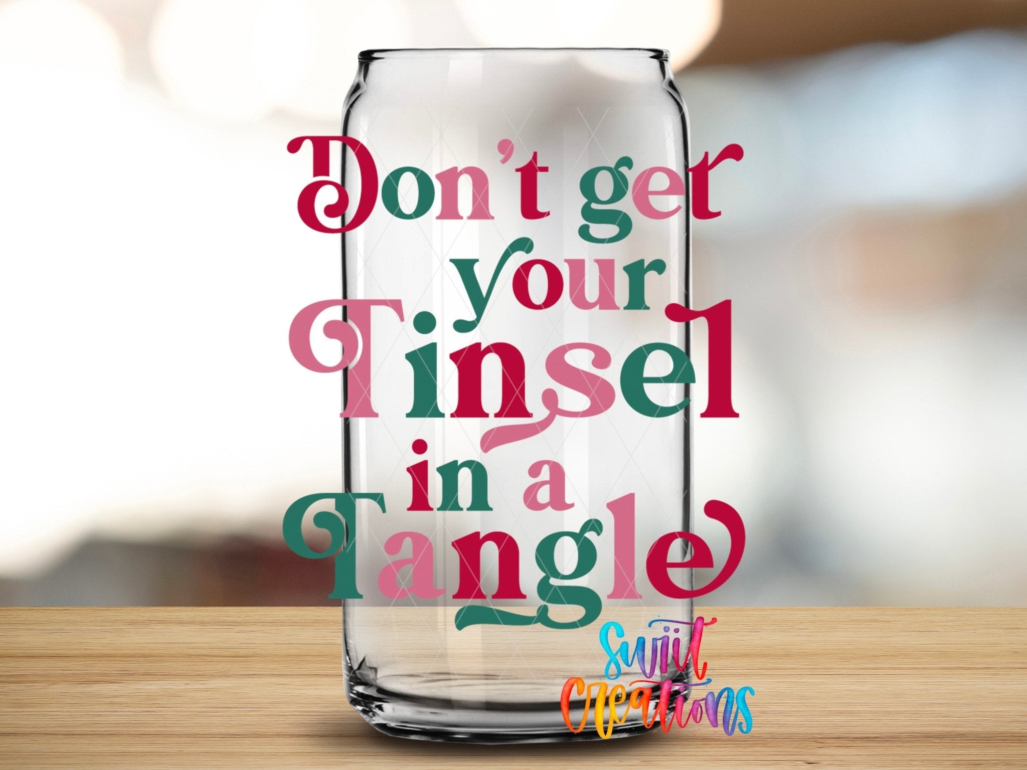 Swiit Creations UV DTF Don’t Get Your Tinsel In A Tangle transfer applied to a clear glass can