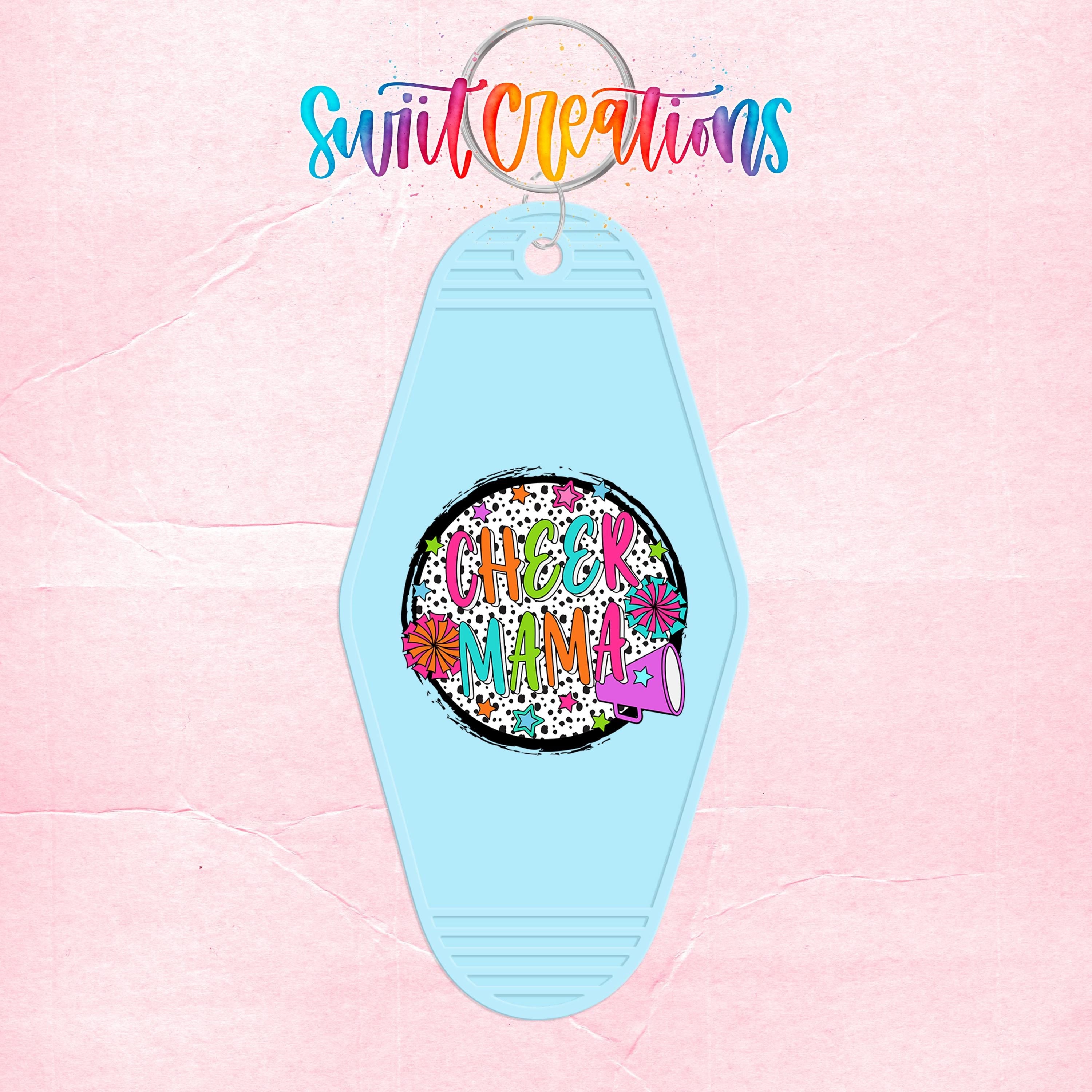 A keychain with a colorful, whimsical design featuring the text "Cheer Mama" and a flower-like element.