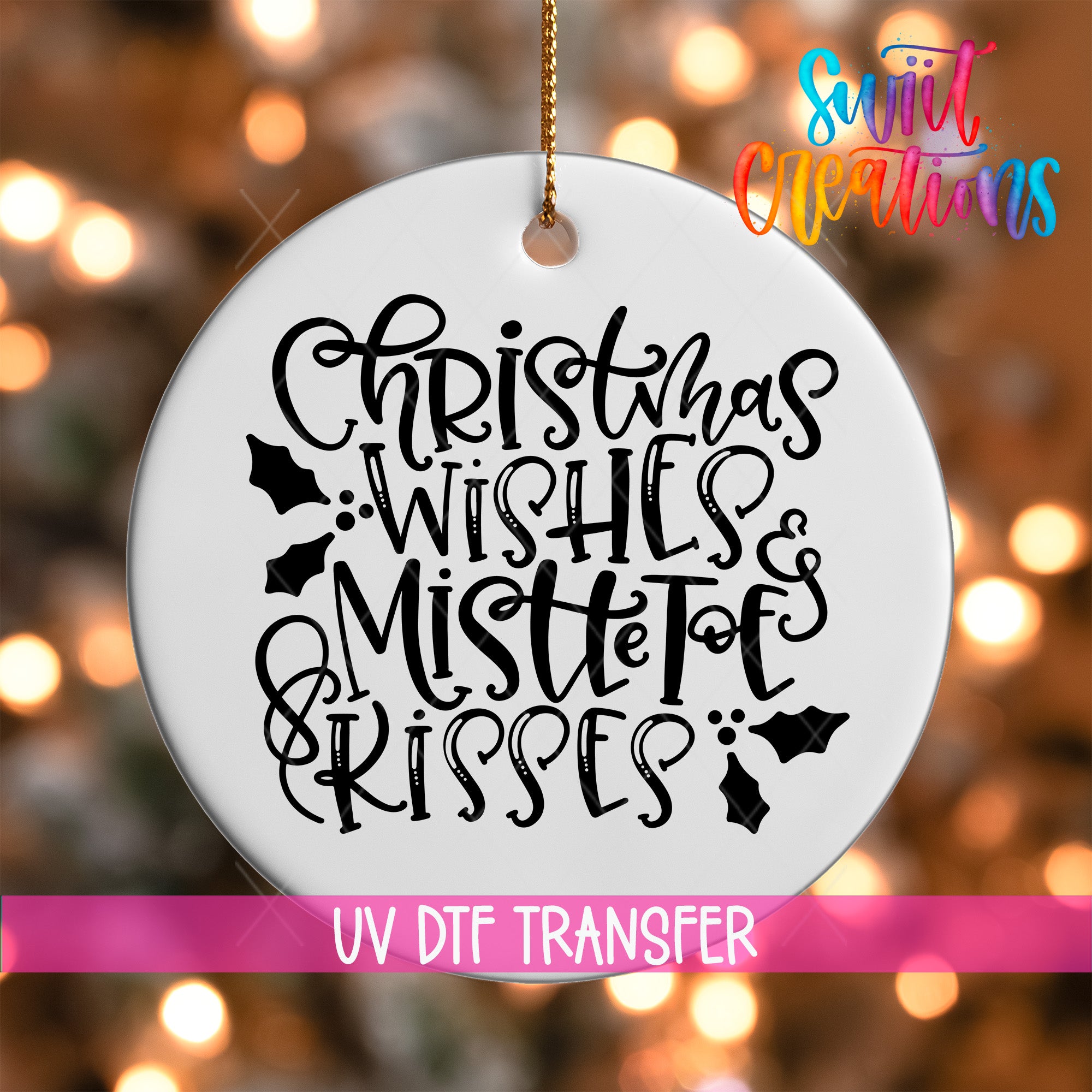 A white ornament with black text that says "Christmas Wishes & Mistle Toes Kisses" hanging on a string.