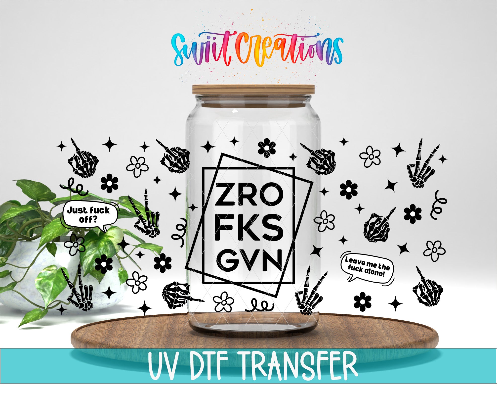 a clear glass jar with various hand-drawn designs and text on it, placed on a wooden surface.