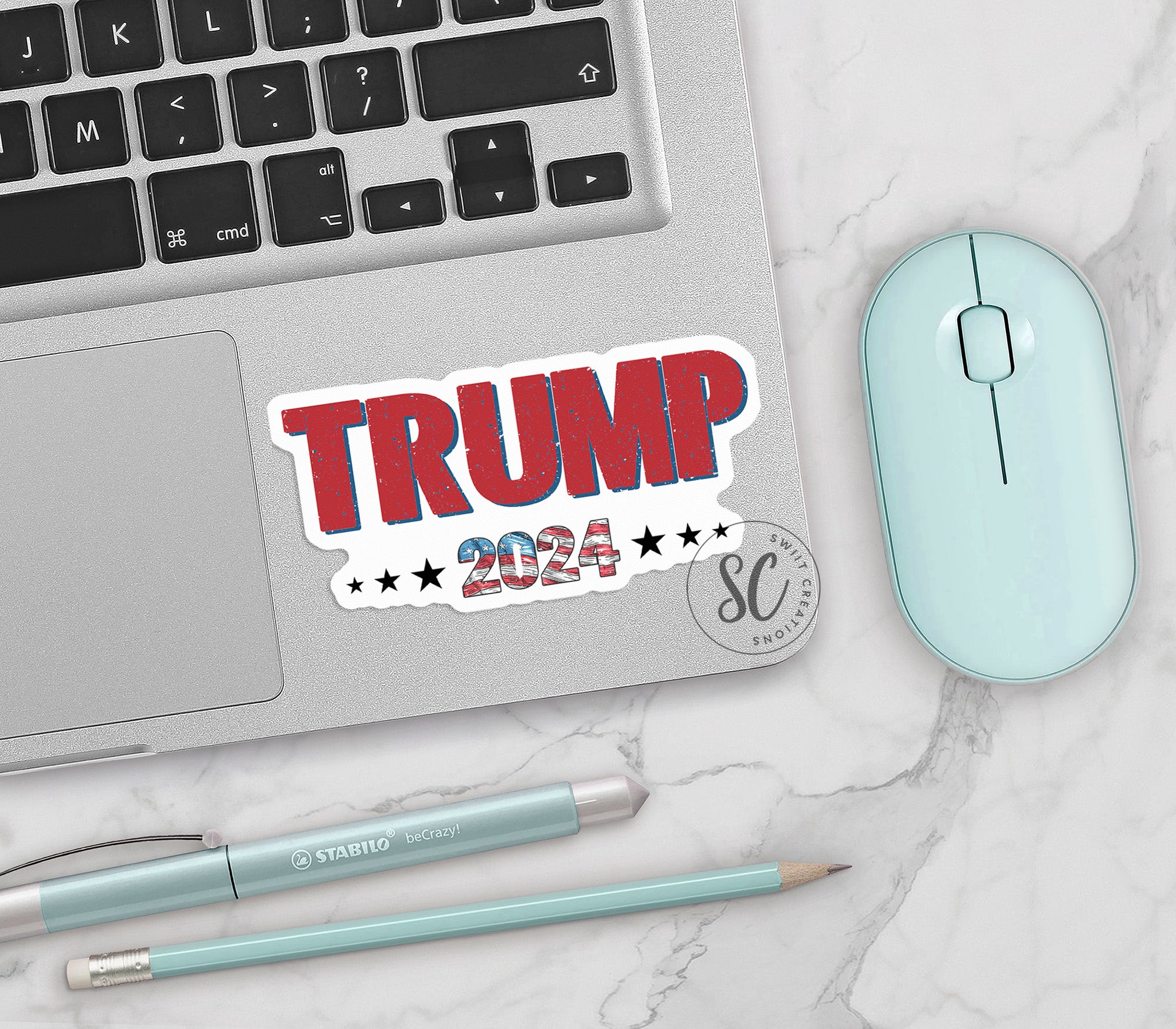 a sticker that says trump on it next to a mouse