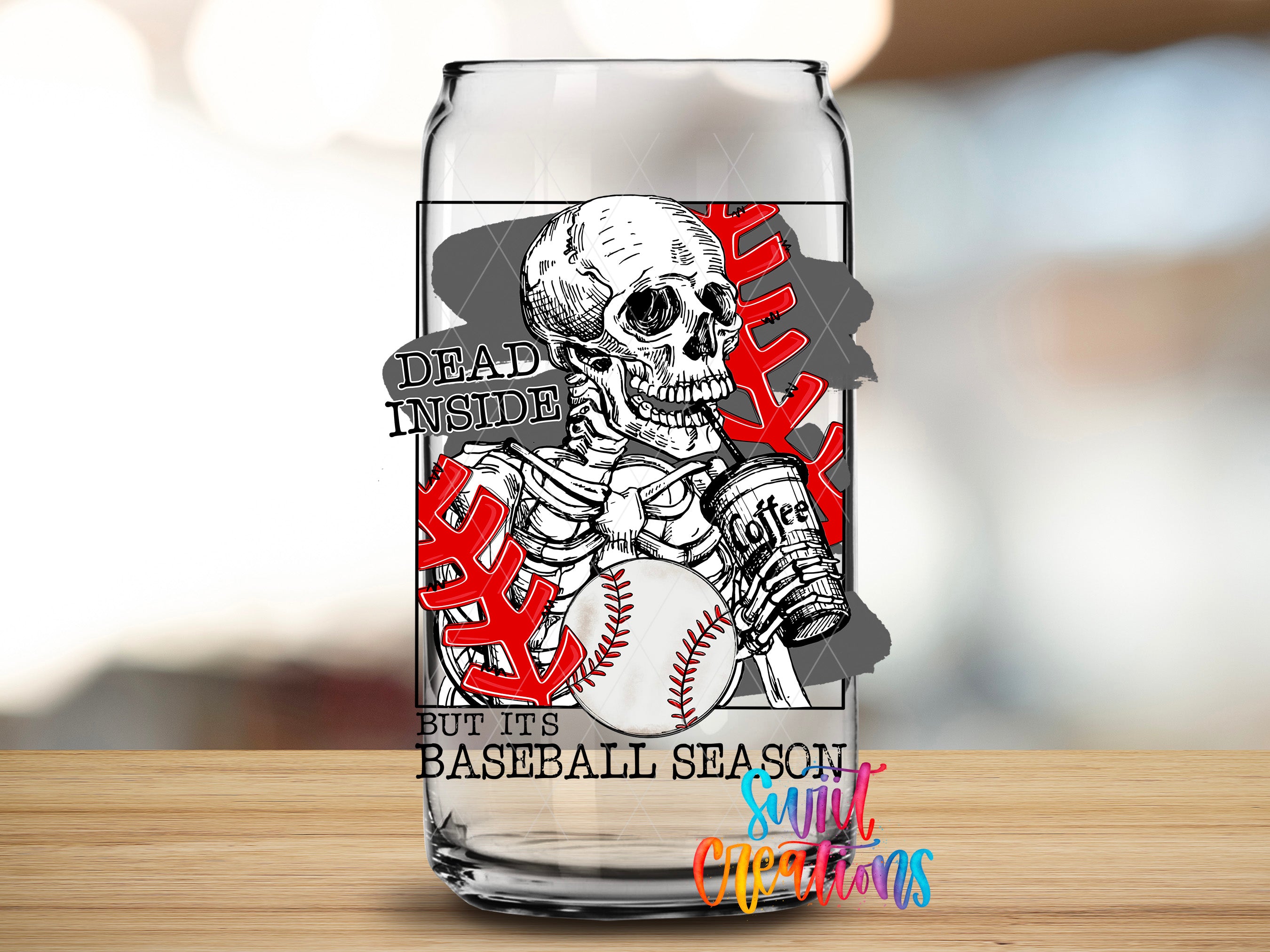 A glass can with a baseball-themed design featuring a skeleton holding a baseball and the text "Dead inside but it's baseball season" printed on it.