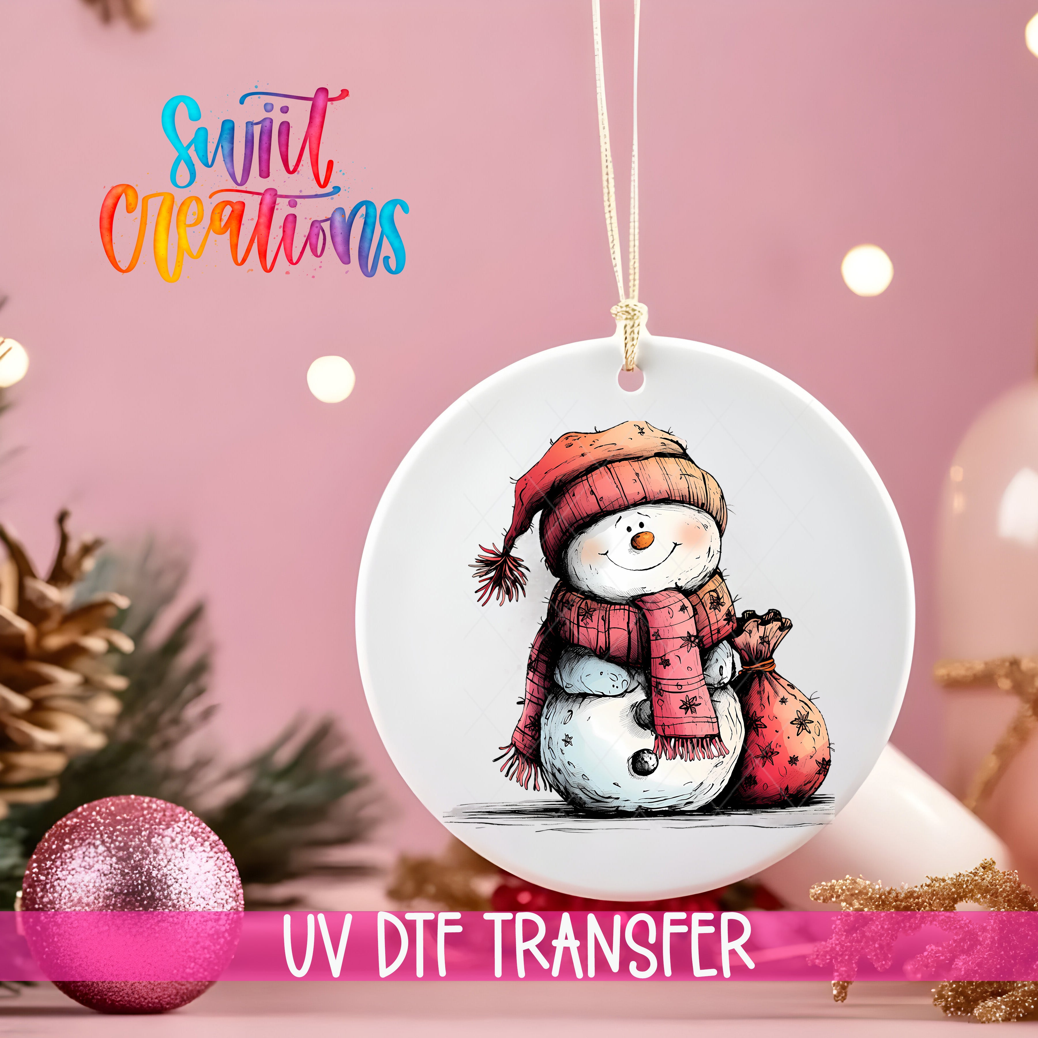 A white ornament with a snowman design is hanging on a pink background, accompanied by a pink glitter ornament and Christmas lights.