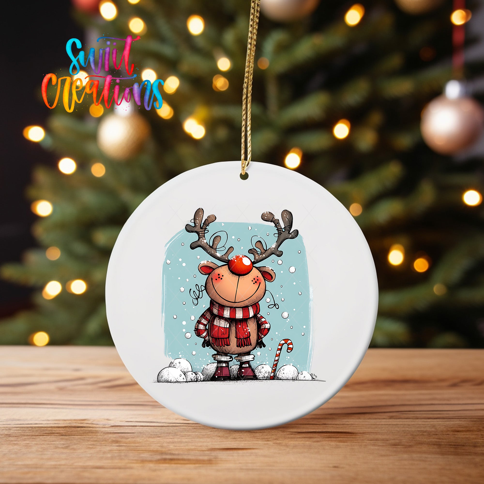 A white oval ornament featuring a cartoon reindeer with antlers and a red nose, standing on a snowy surface.