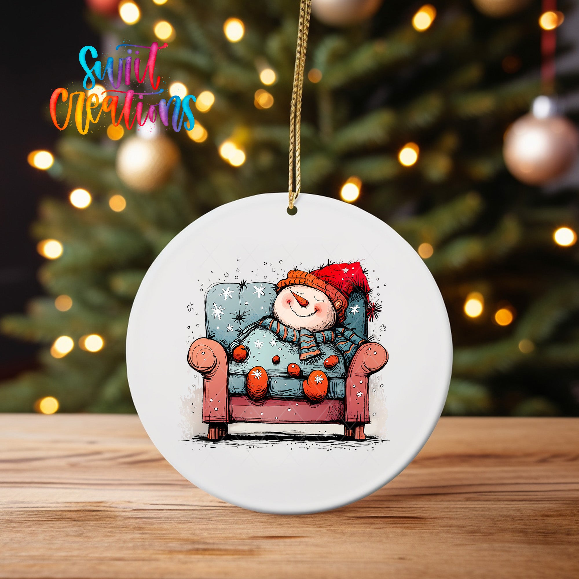 A white ceramic ornament featuring a snowman sitting in a chair, with a Christmas tree in the background.