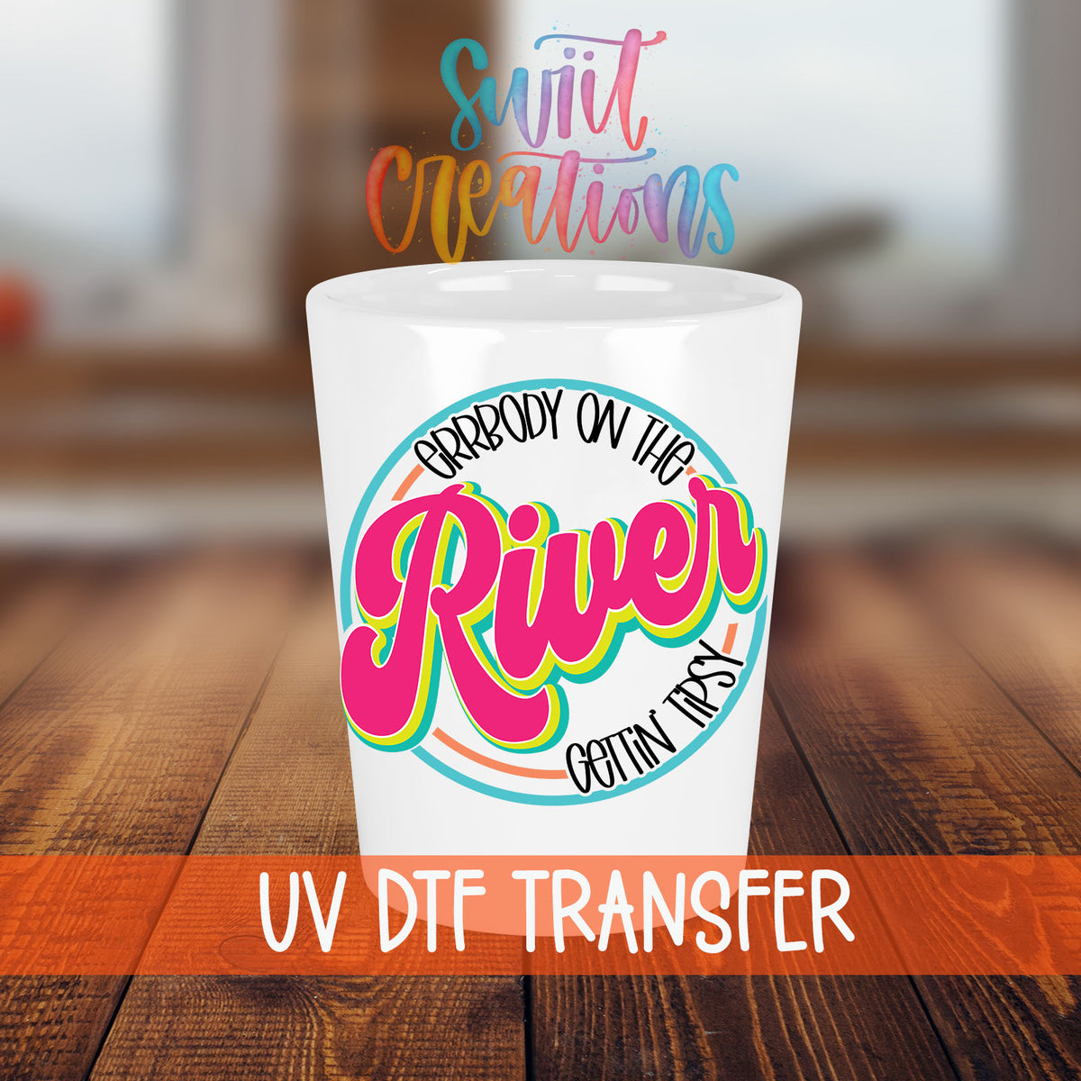 Everybody on the River Gettin Tipsy shot glass transfer on a white shot glass on a wooden table