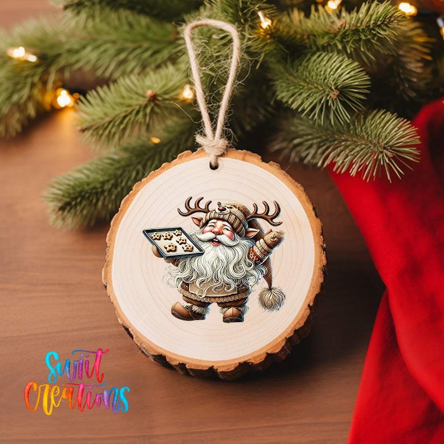 A wooden ornament featuring a cartoon Santa Claus figure holding a tray of cookies, hanging on a Christmas tree.