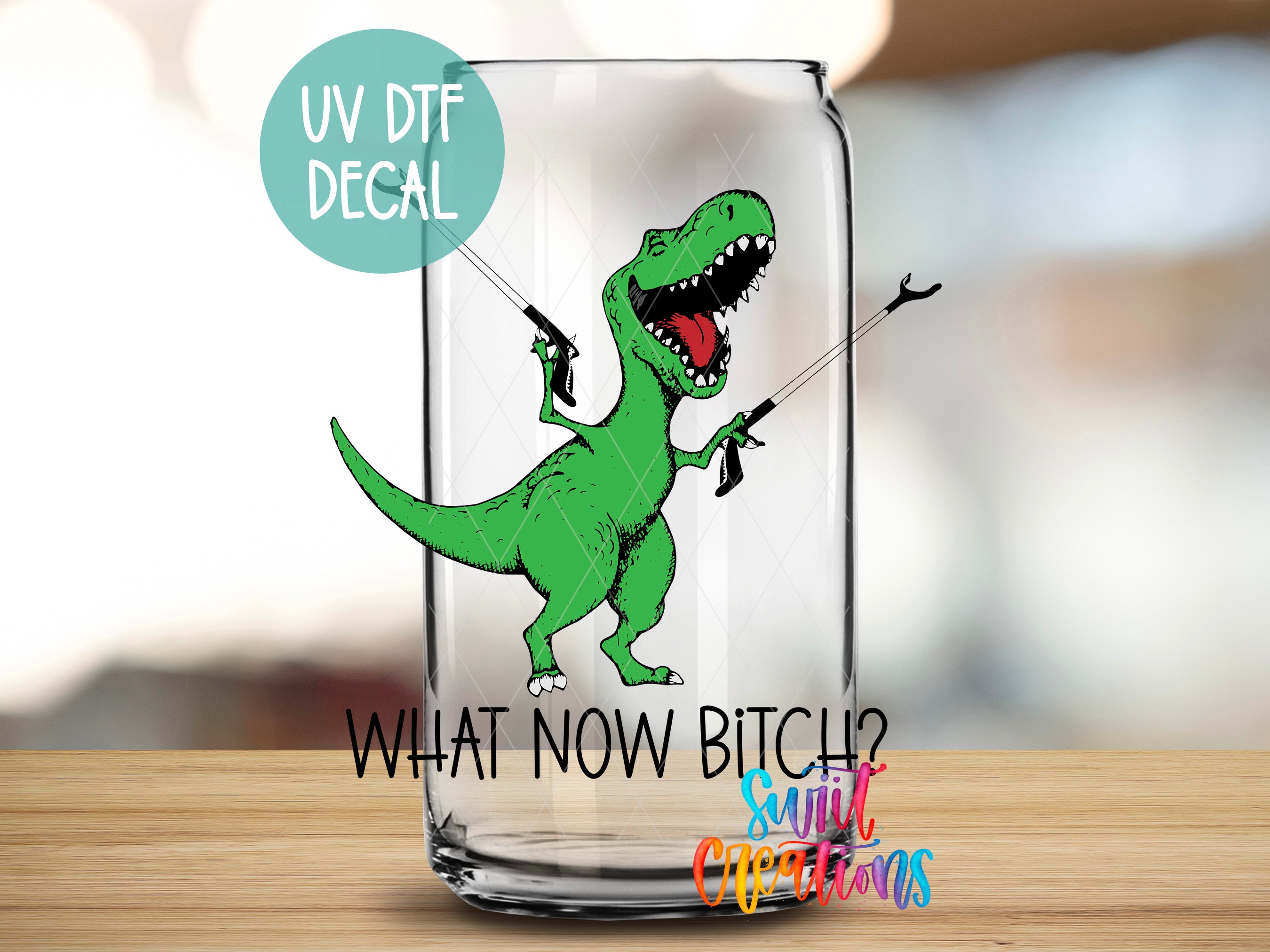 A dinosaur illustration on a glass jar with the text "UV Dtf DECAL" and "WHAT NOW BITCH? SINC Christmas" printed on it.