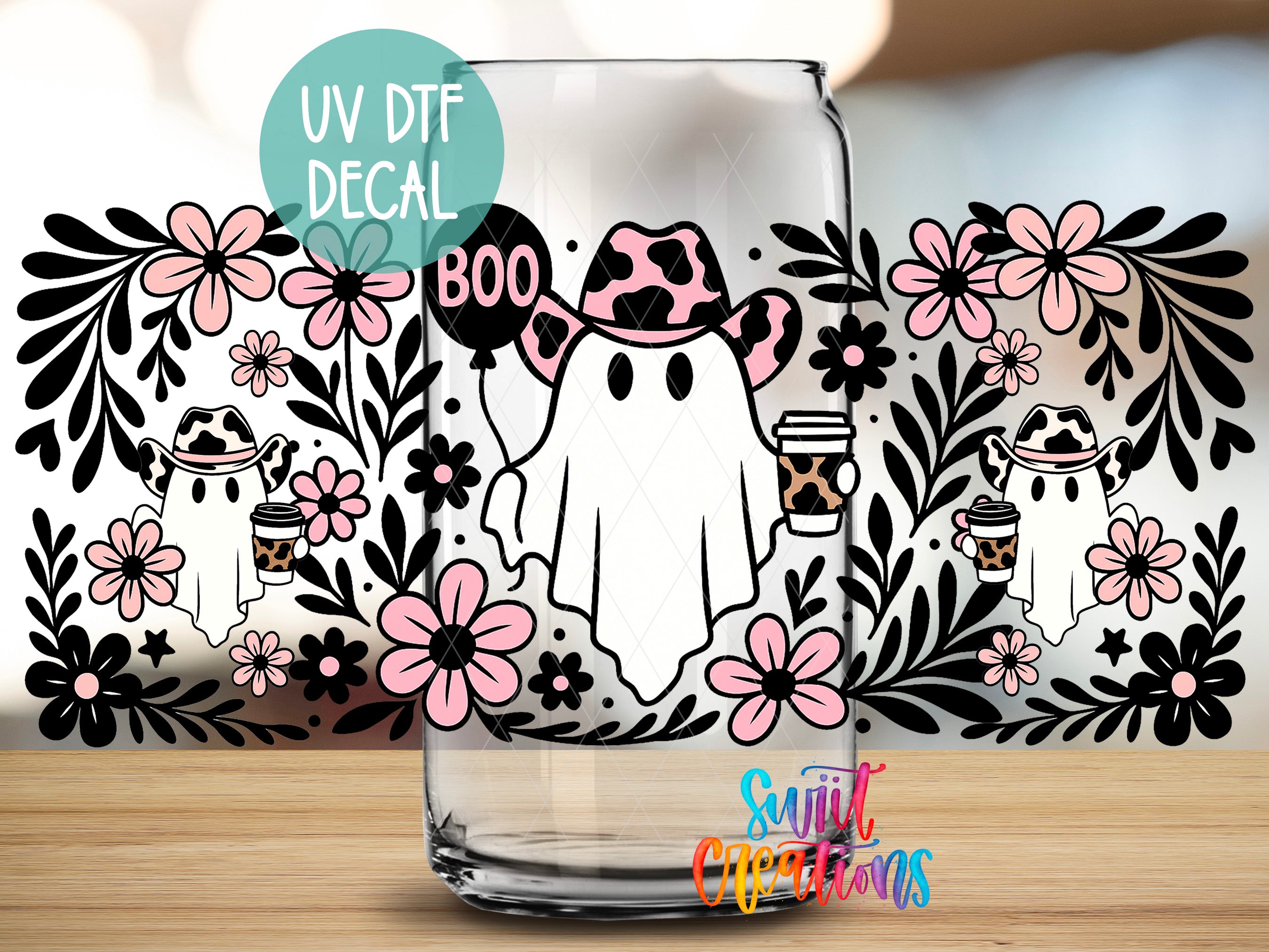 a glass mug with a Halloween-themed decal. The decal includes a ghost wearing a cowboy hat and holding a coffee cup, surrounded by flowers and leaves. The mug is placed on a wooden surface, and there is a text overlay that reads "UV Dtf DECAL" and "Boo".