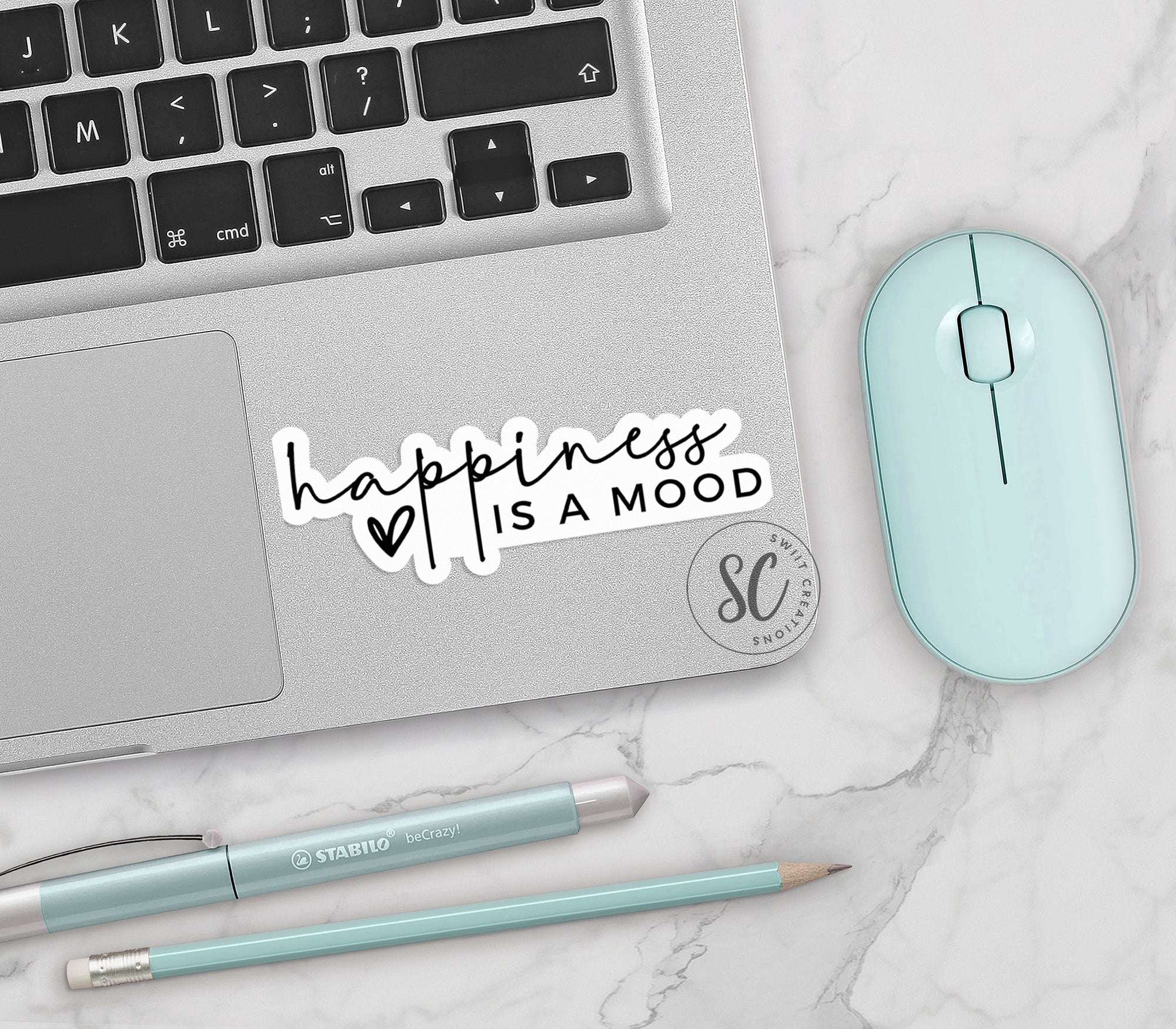 a laptop with a sticker that says happiness is a mood