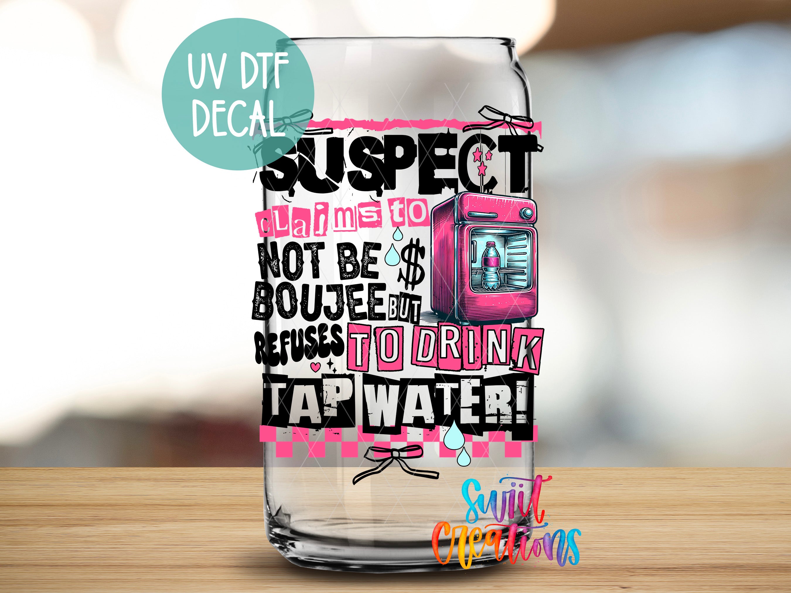 a glass jar with a pink and black design, including text and an illustration of a pink object, such as a television or a toy.