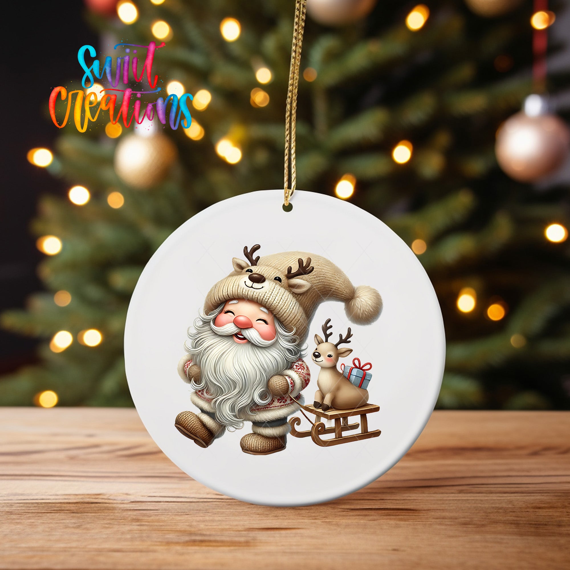 A white ornament featuring a smiling Santa Claus with reindeer and a gift, set against a blurred background of a Christmas tree with twinkling lights.