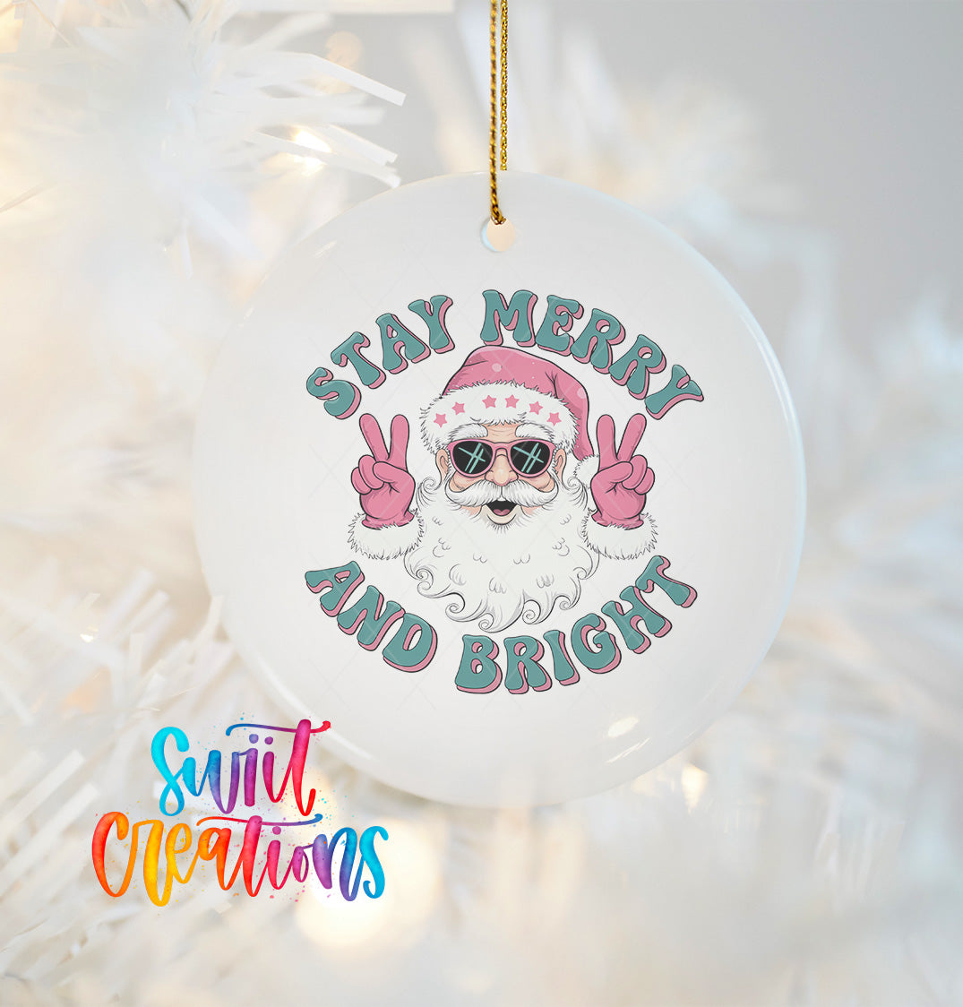 A white ornament with a Santa Claus design and the text "Stay Merry and Bright" hanging from a string.