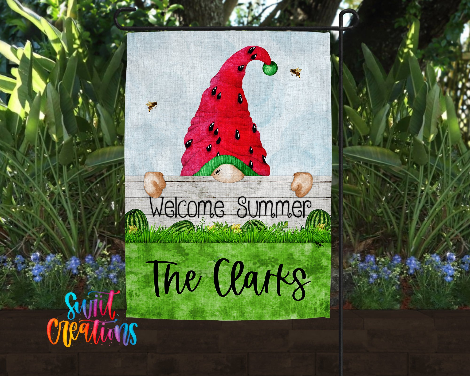 A garden gnome wearing a red hat with a green ball and surrounded by a lush green lawn and colorful flowers.