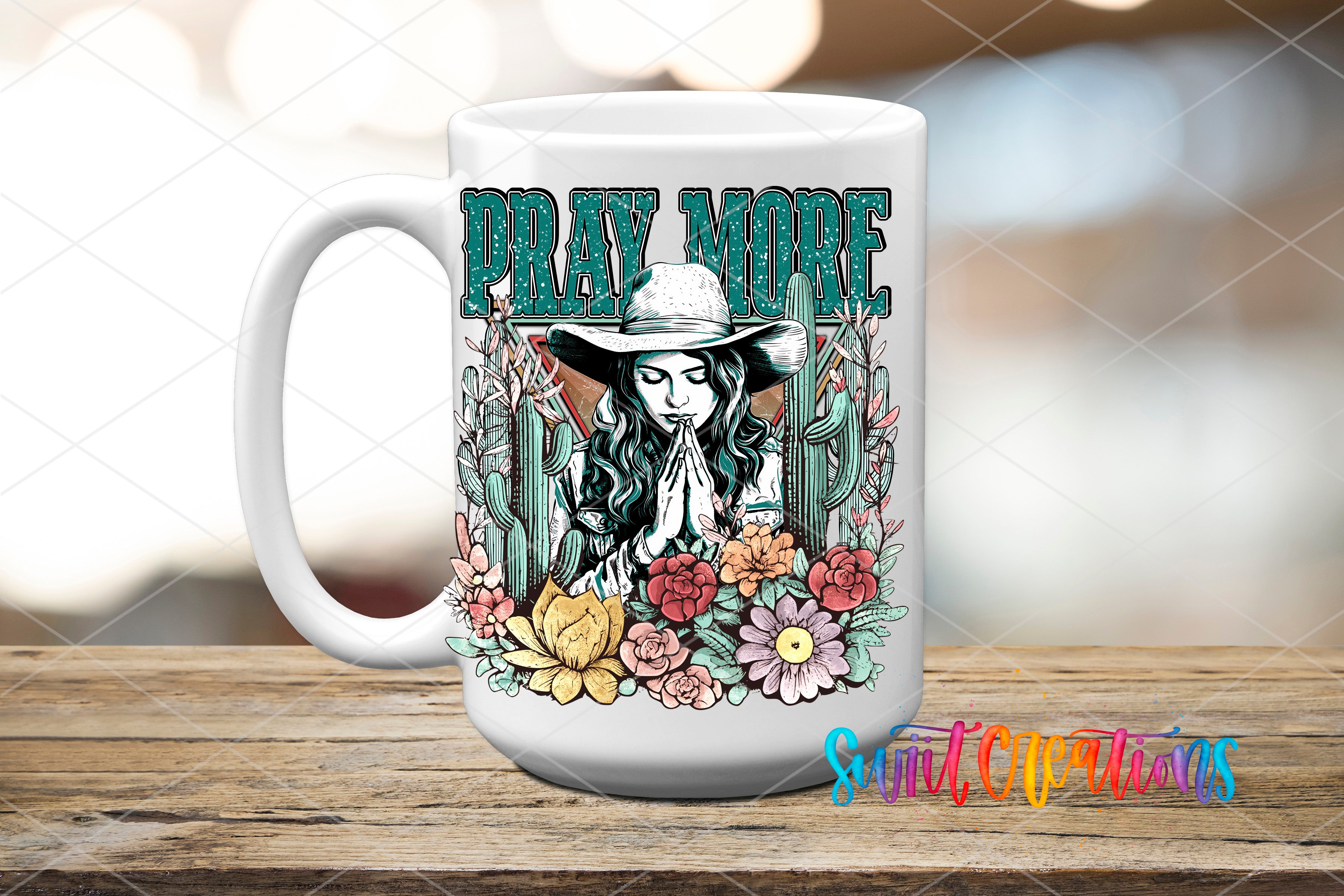 A white ceramic mug with a colorful graphic design featuring a woman praying surrounded by flowers and cacti.