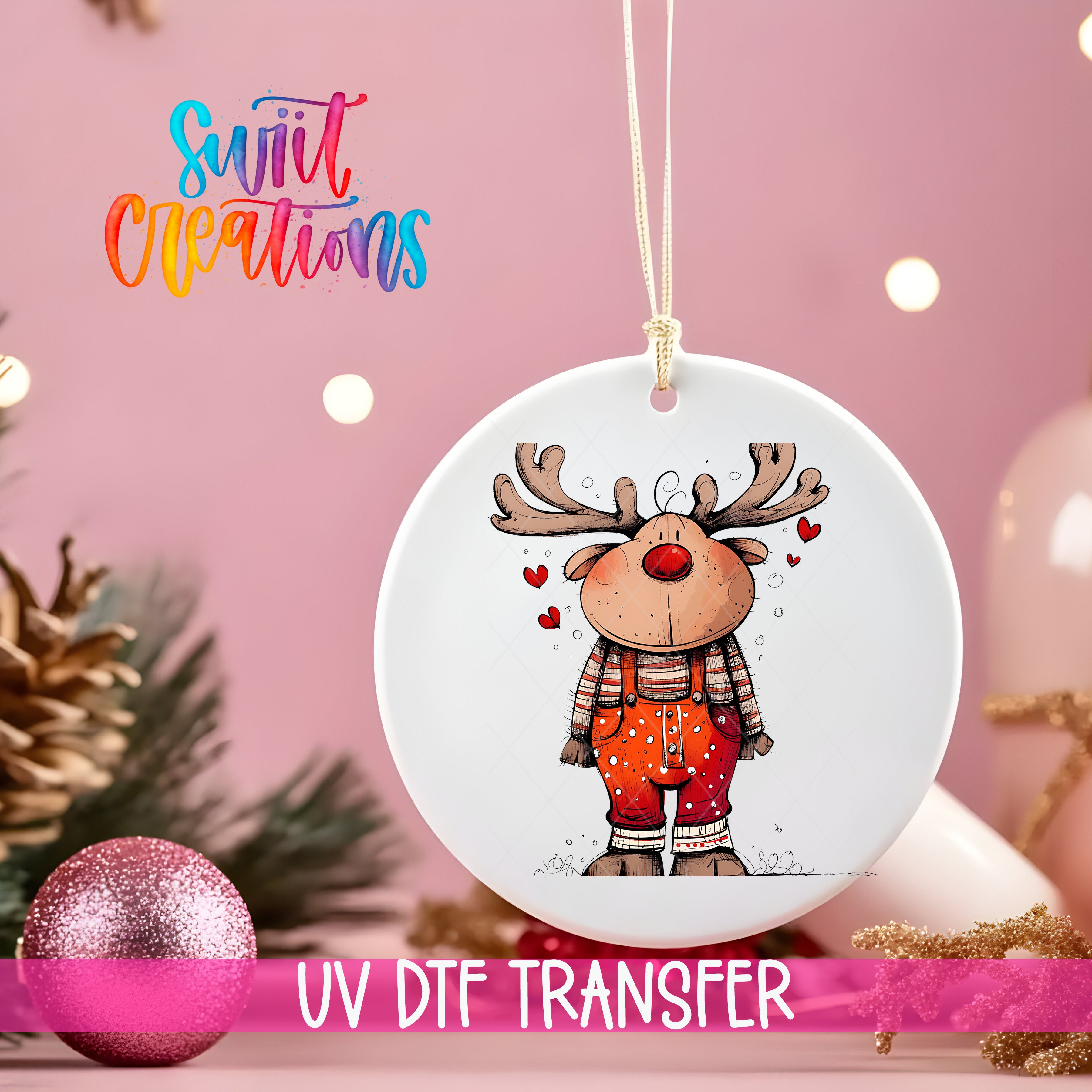 A white ornament with a cartoon reindeer design hangs against a pink background, with a pink glitter ball and Christmas tree decorations visible in the background.