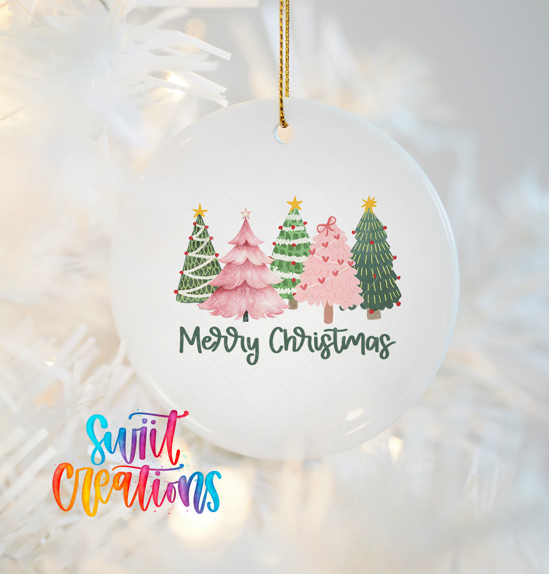 A white Christmas ornament with a festive design of four different colored Christmas trees, along with the text "Merry Christmas" written on it.