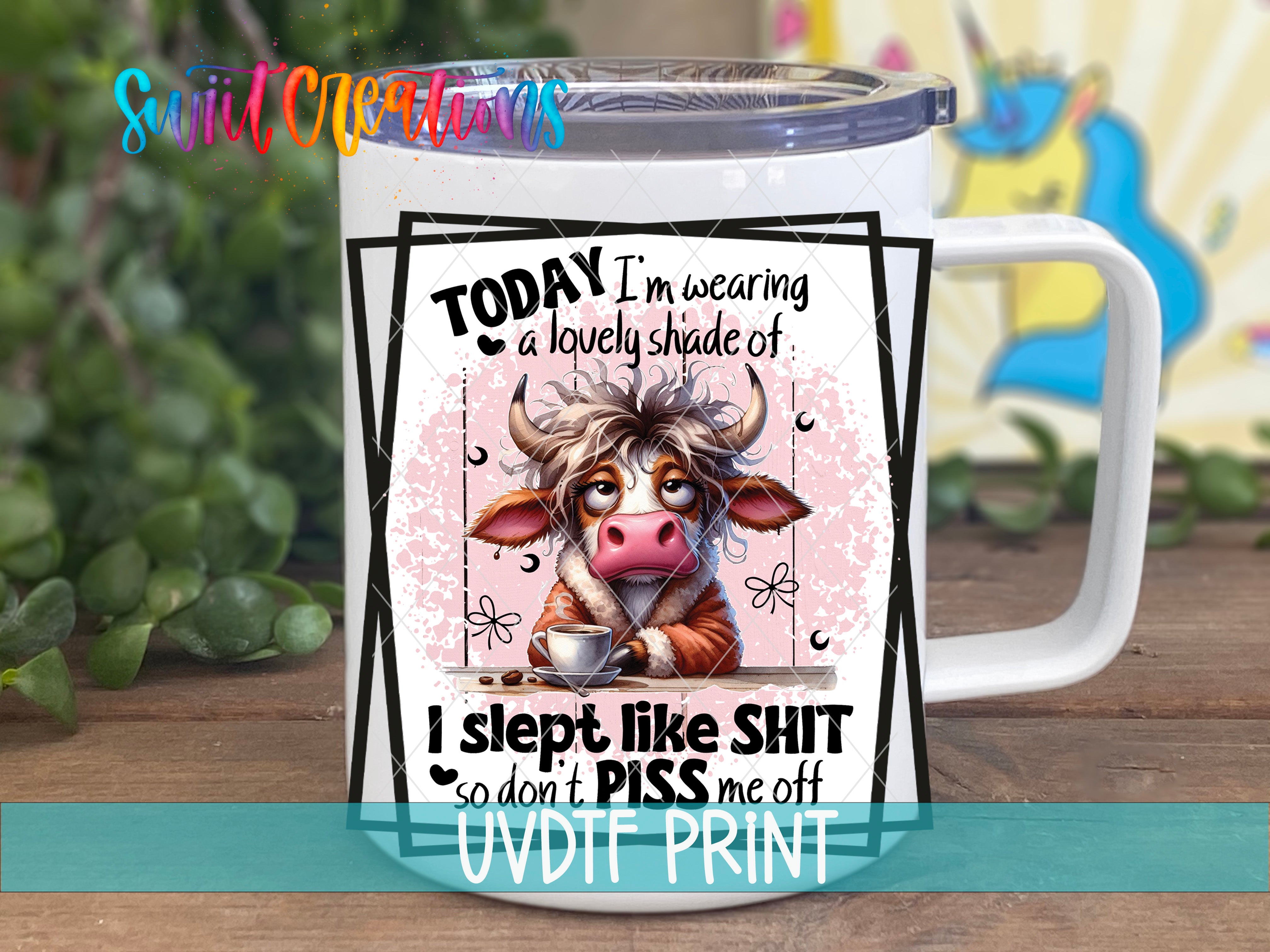 A mug with a cartoon cow design and text on it.