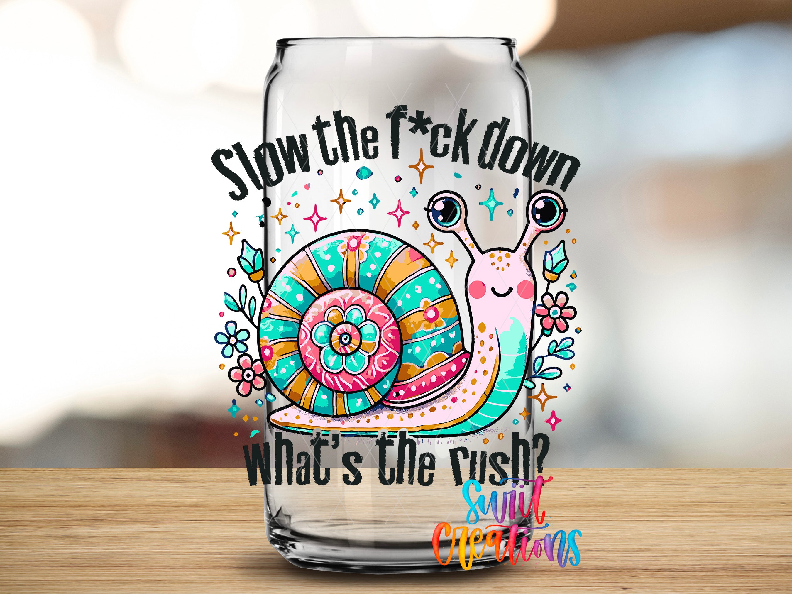 A glass jar with a colorful illustration of a snail and the text "Slow the fuck down, what's the rush? Sunflowers" printed on it.