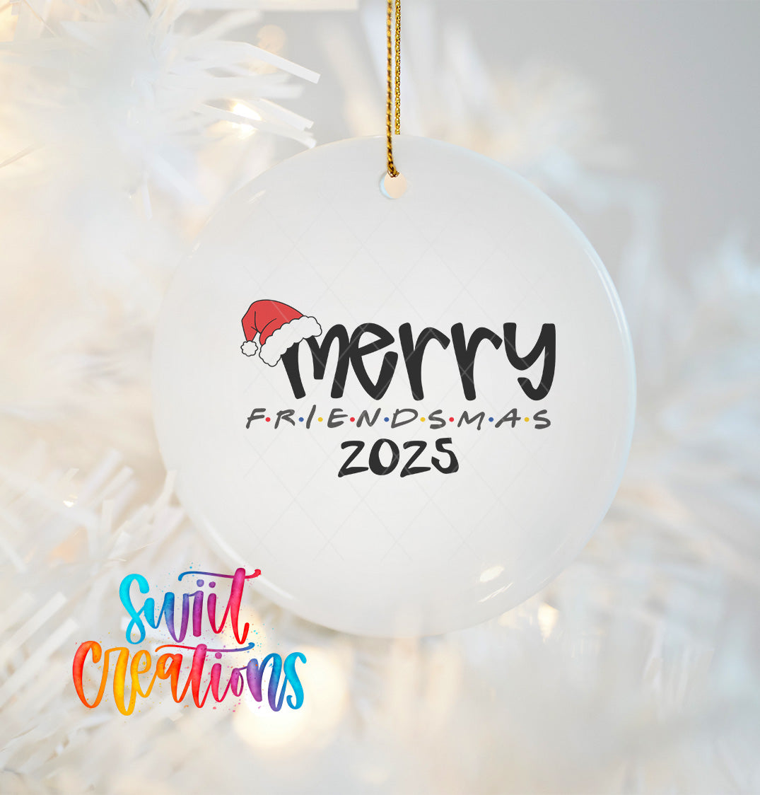 A white ornament with a Santa hat and the text "Merry FriendsDSMAS 2025" hanging on a string.